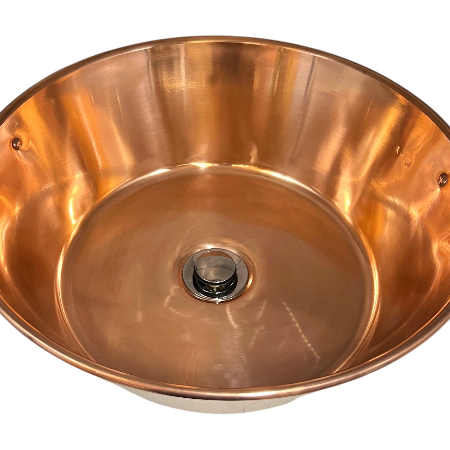 French copper bowl upcycled into a copper sink with iron handles and a chrome pop up waste on a white background