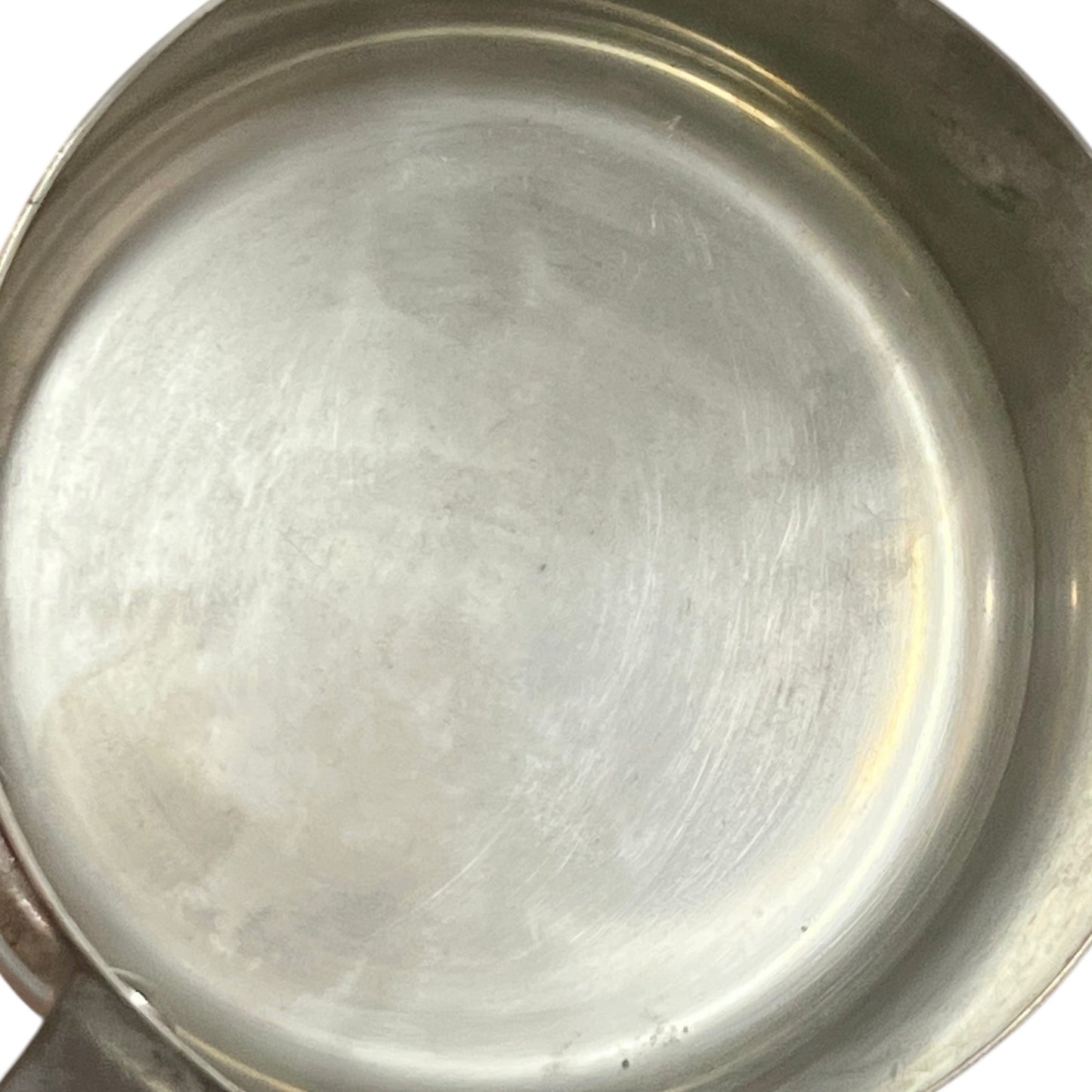 Close-up of copper cookware with iron handles on a white background
