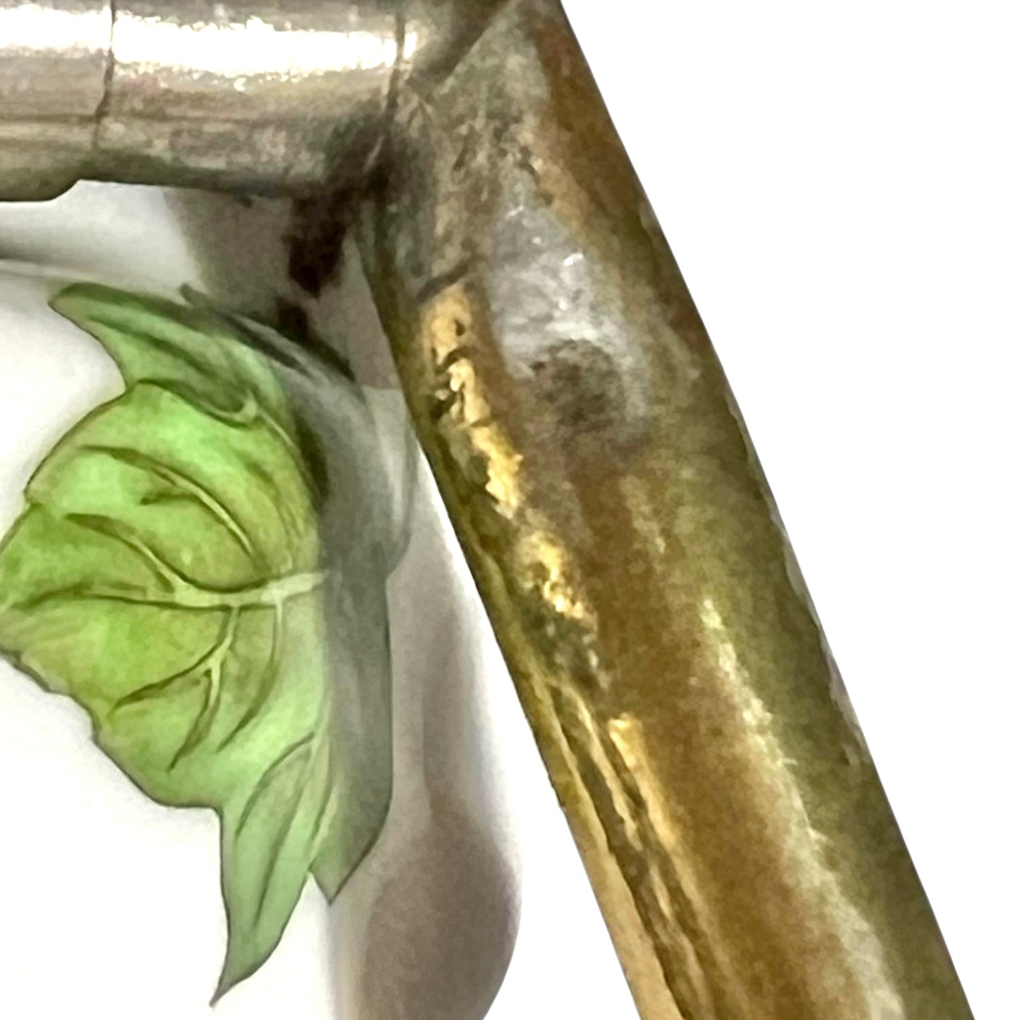 close up of towel hoop with leaf design on a white background
