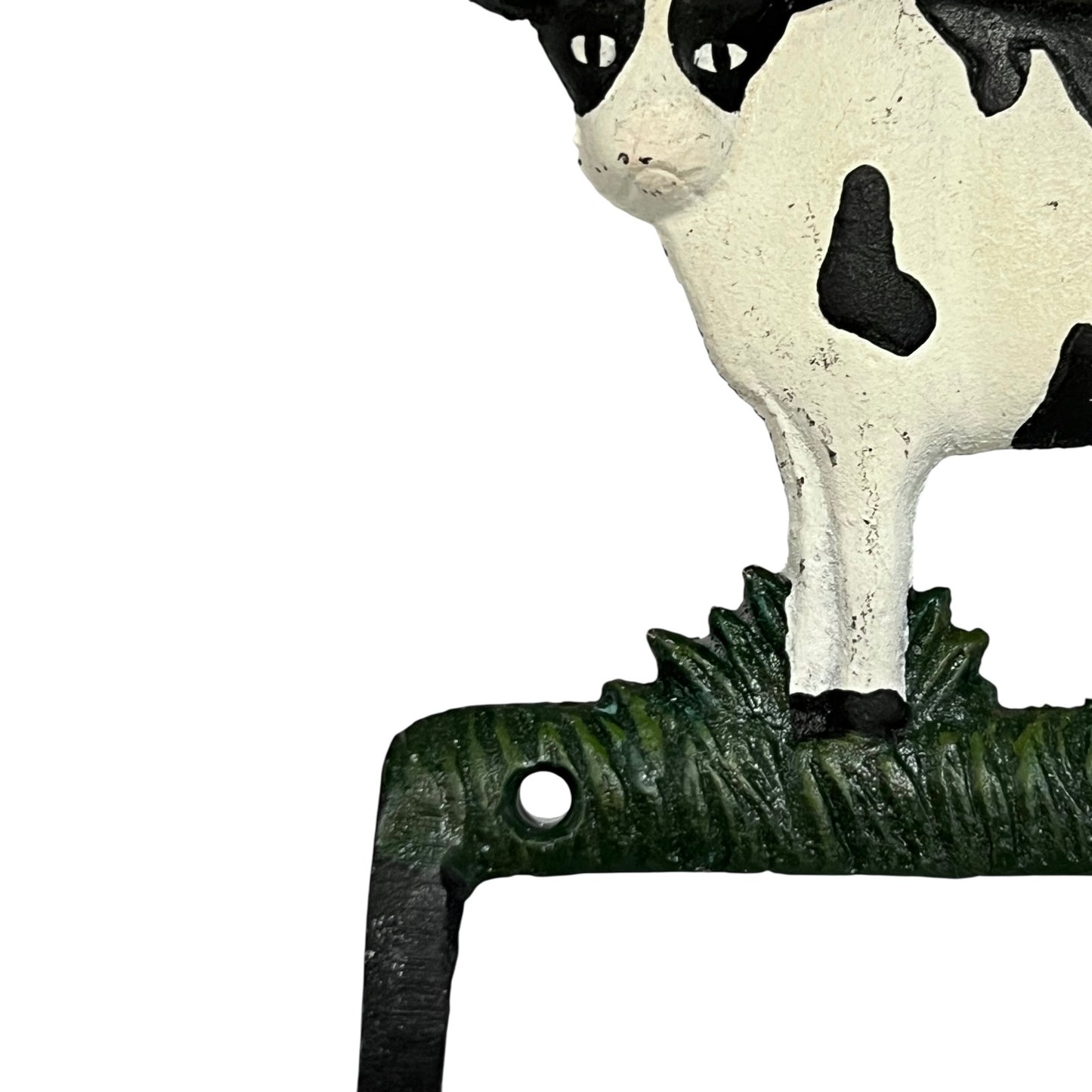 Close up of cow toilet paper holder with black and white pattern on a white background