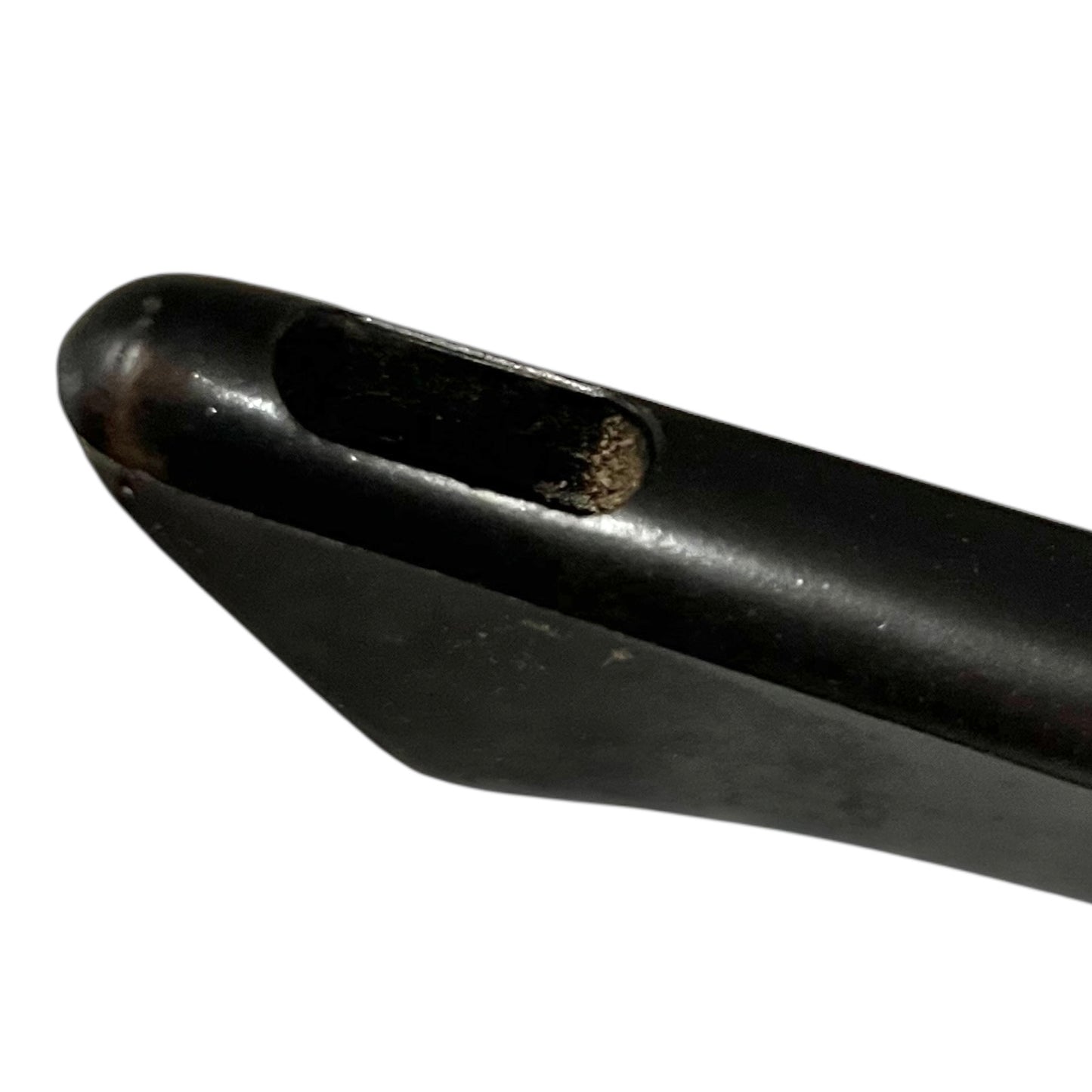 Close-up of a black handle of a frying pan on a white background