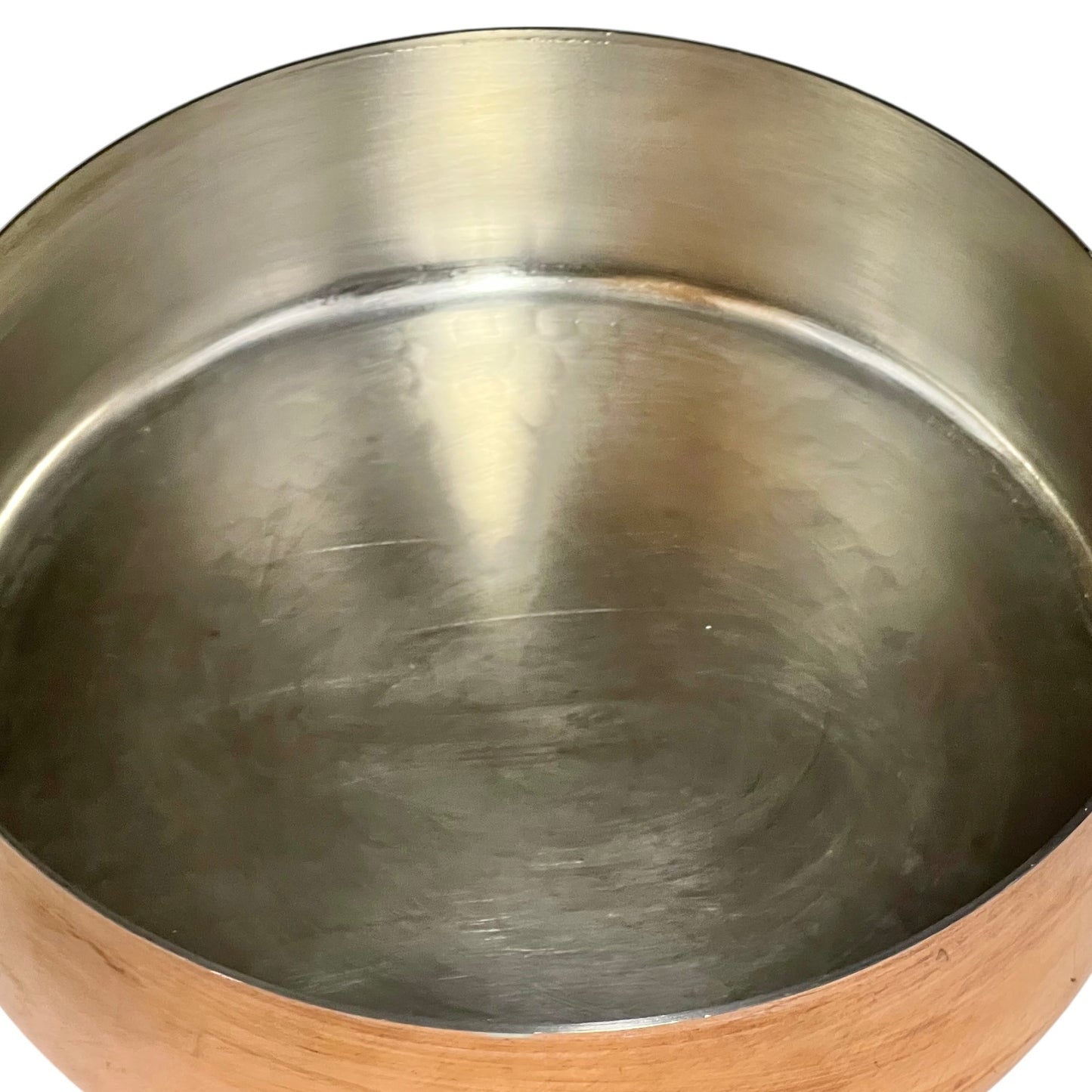 tin lined copper pot with brass handle on a white background
