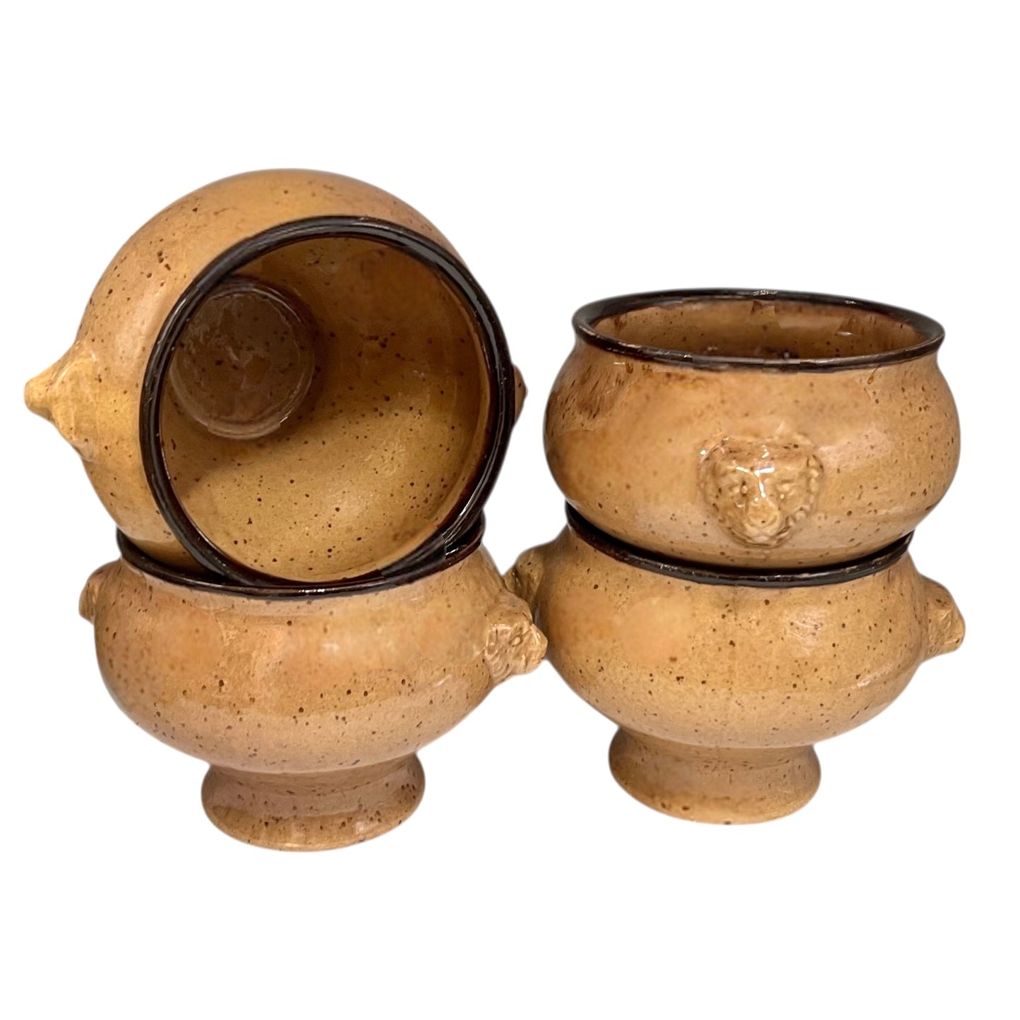 Set of four speckled beige lions head soup bowls with dark rims on a white background