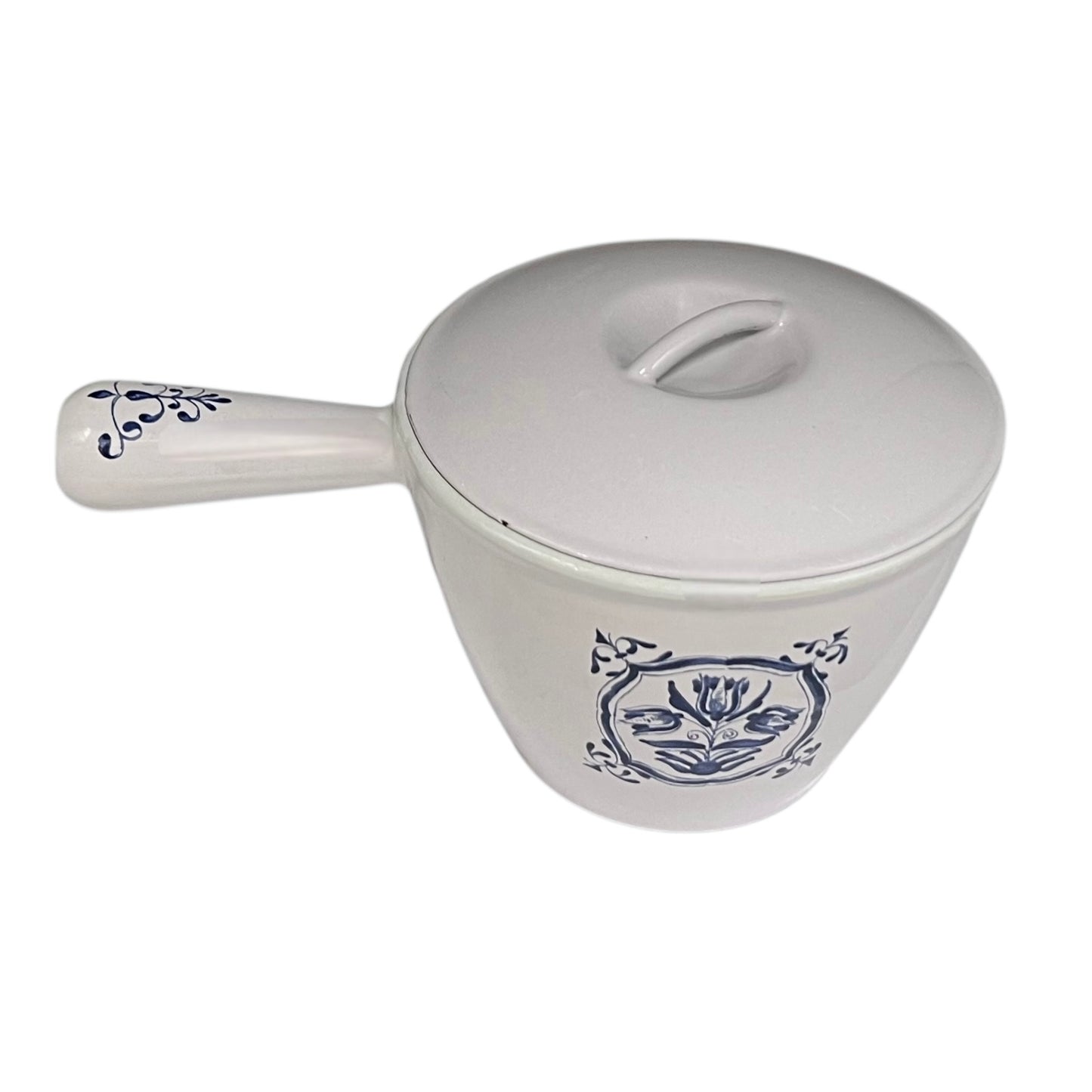 White enamelled cast iron pot with blue floral design and handle on a white background