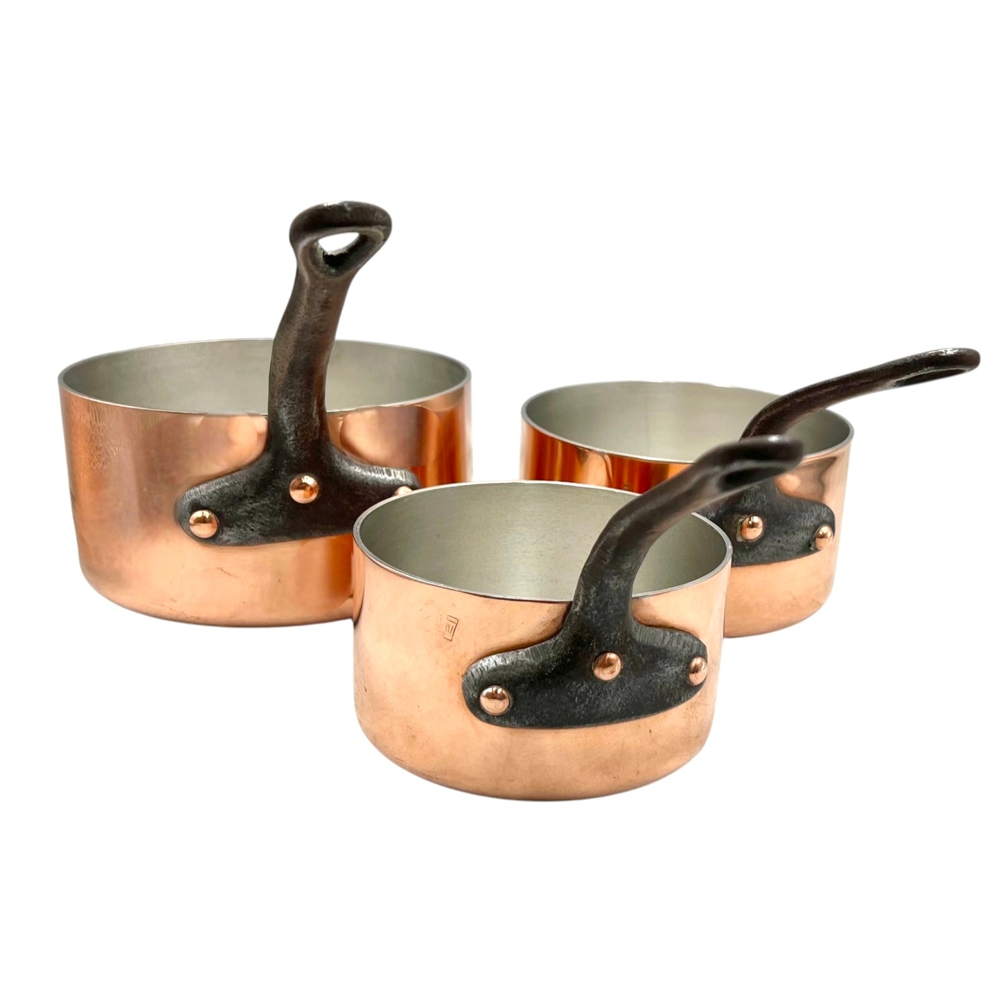 Set of three copper 2mm saucepans with new tin lining and black handles on a white background