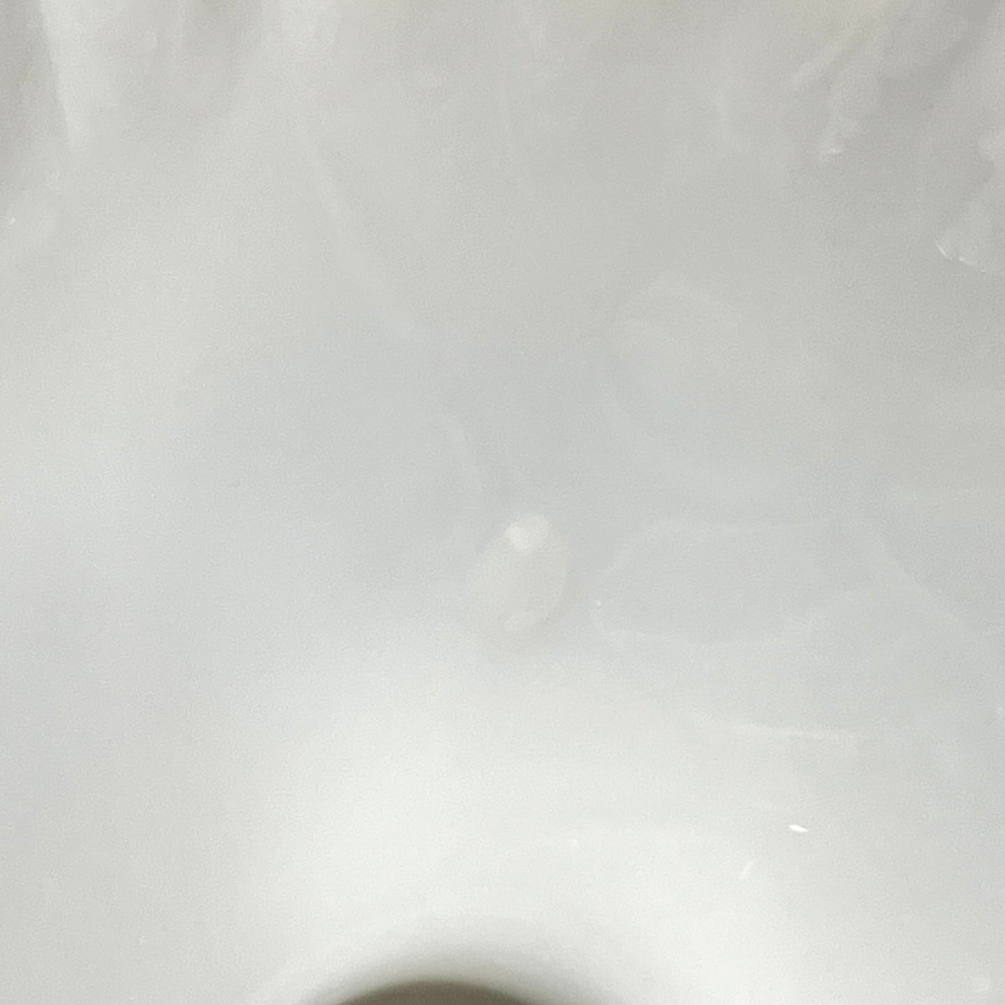 close up condition view of a milk glass lampshade