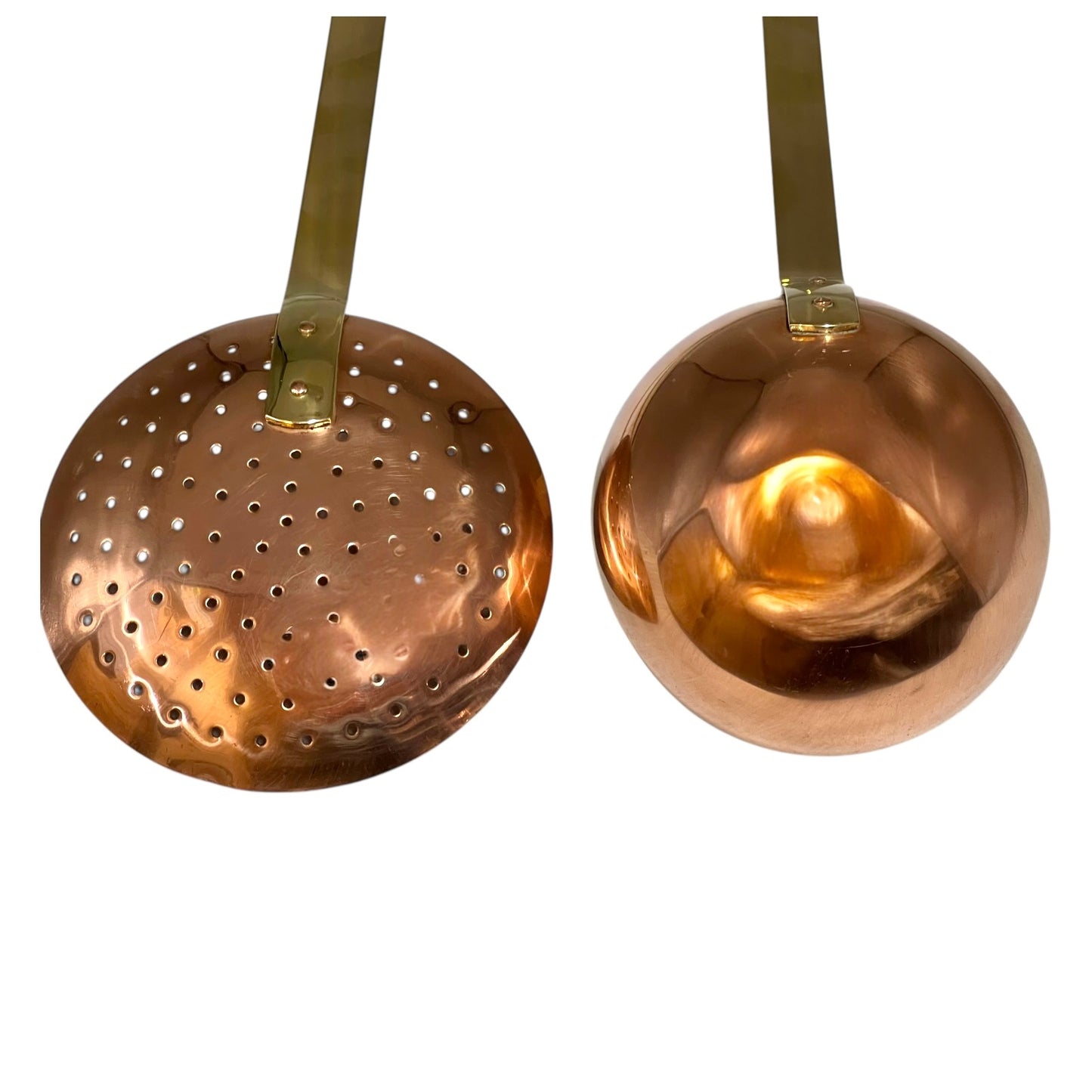 Set of 2 French copper utensils with long brass handles, includes a straining spoon and a ladle on a white background