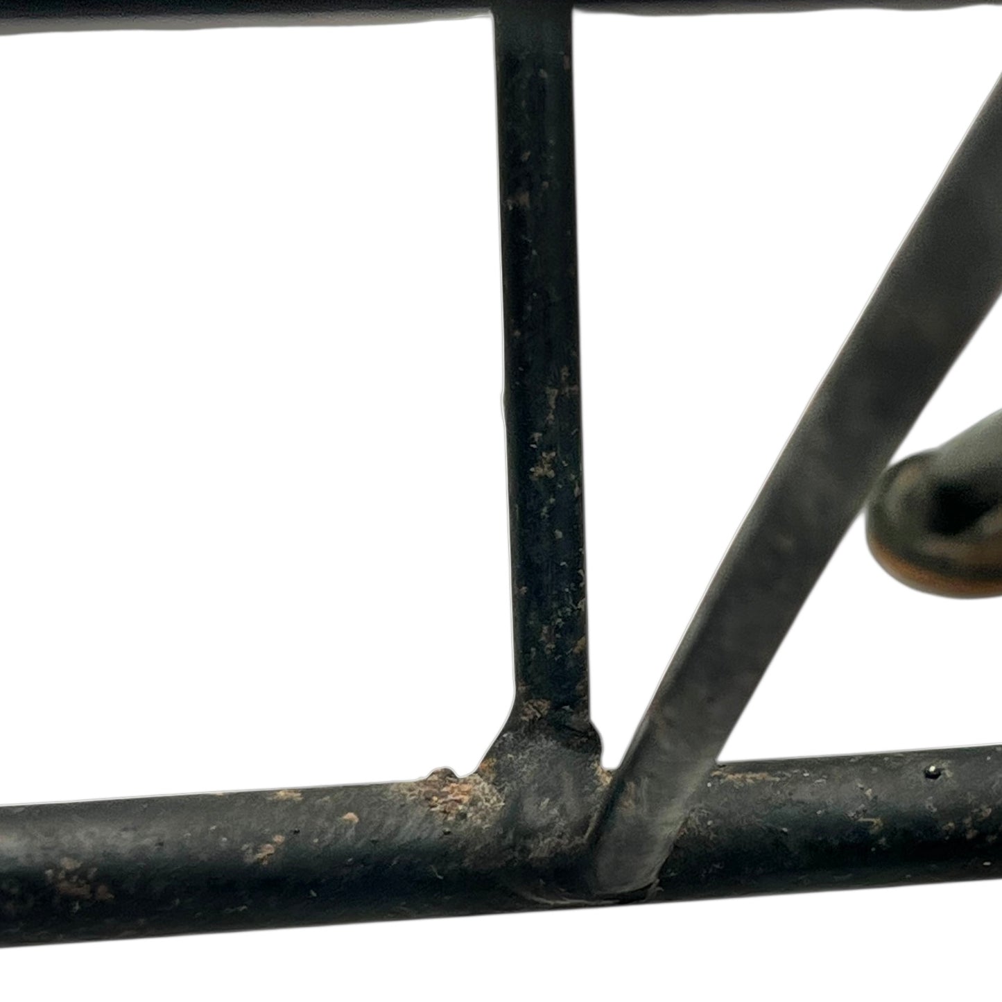 Close-up of a black metal stand on a white background