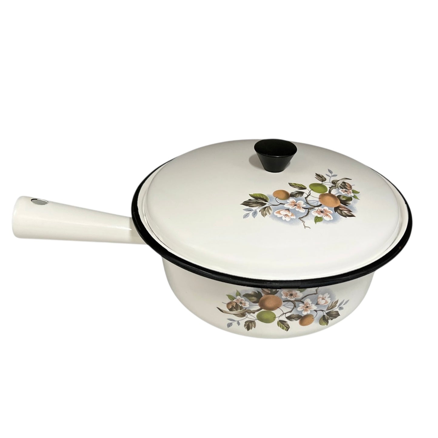 White enamel saucepan and lid with floral design on a white background