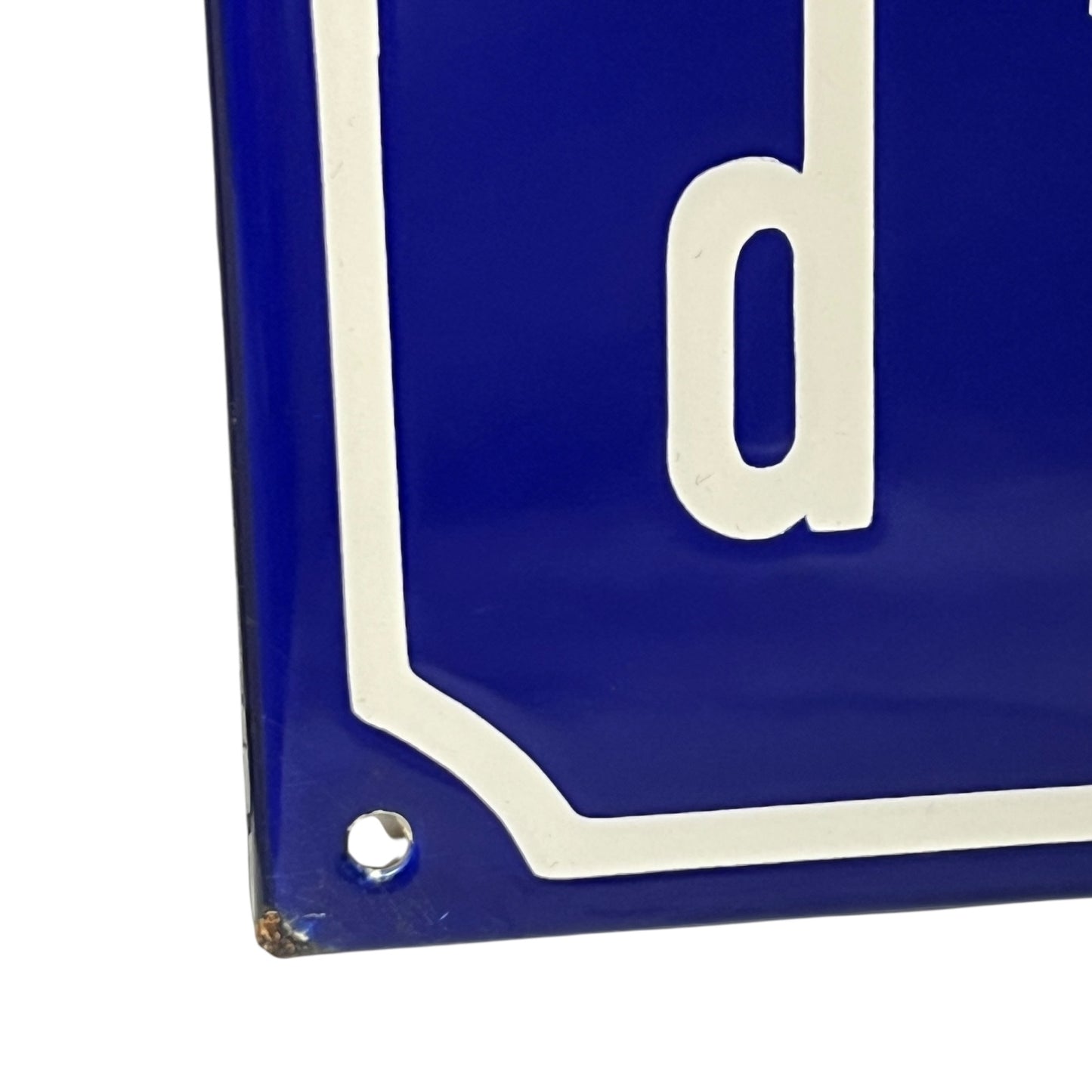 Close-up of a blue and white sign on a white background