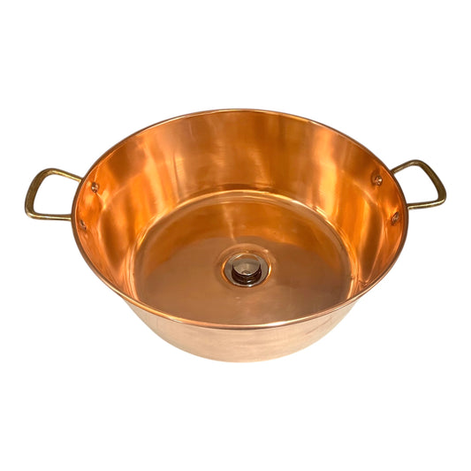 Copper basin with brass handles on a white background