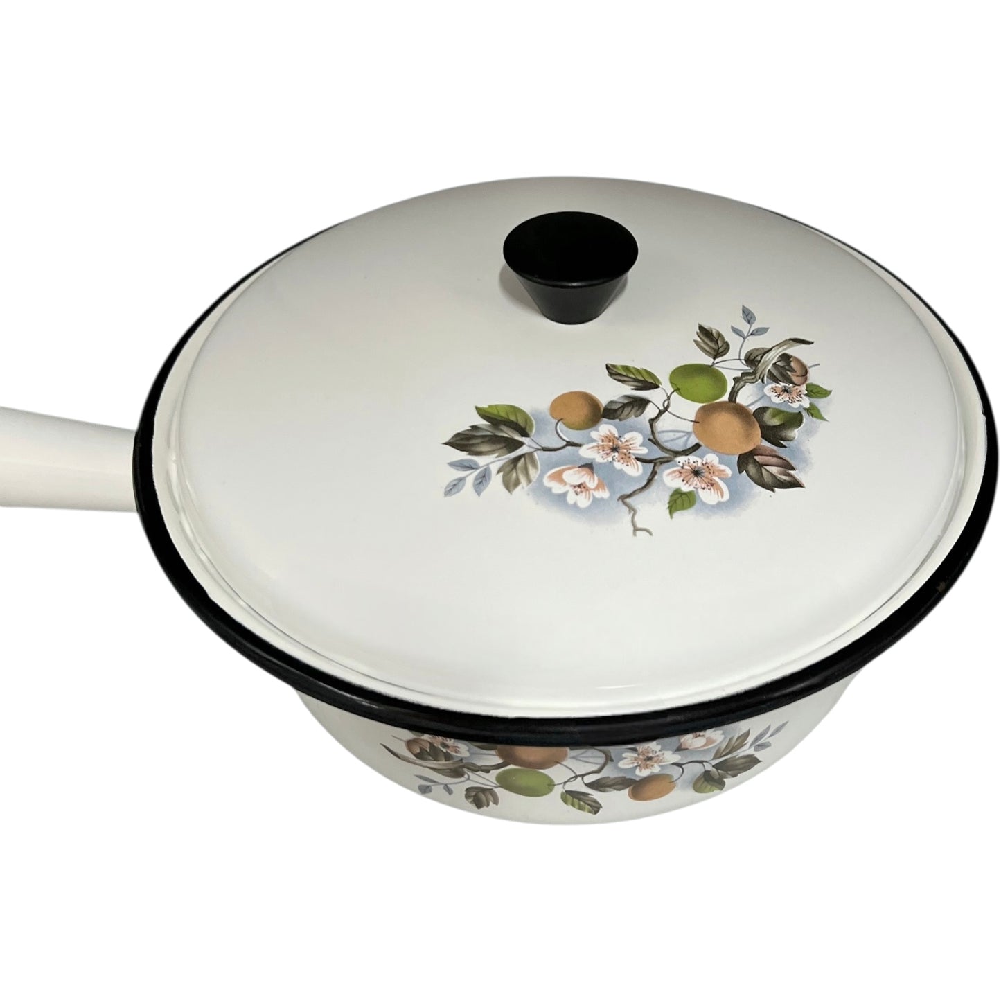 White enamel saucepan and lid with floral design on a white background