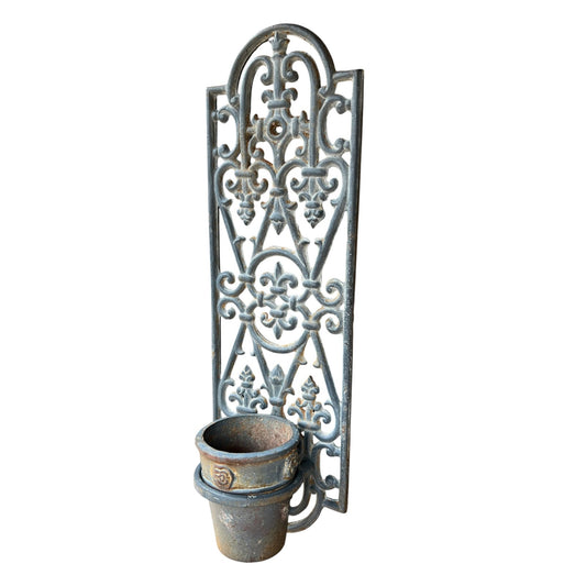Decorative cast iron French vintage metal wall art with a planter pot on white background