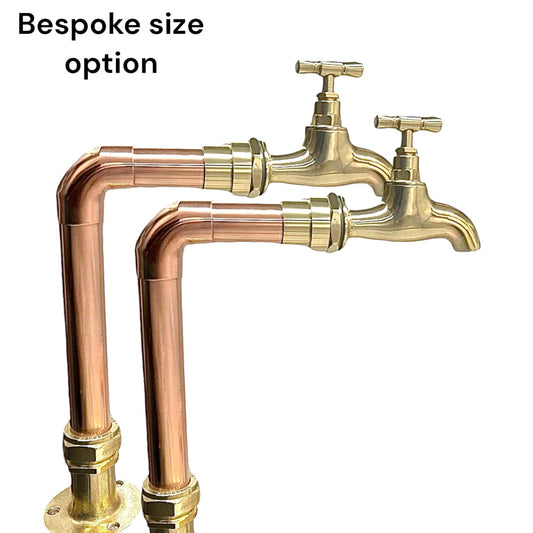 pair of copper taps with brass tap heads in an L shape