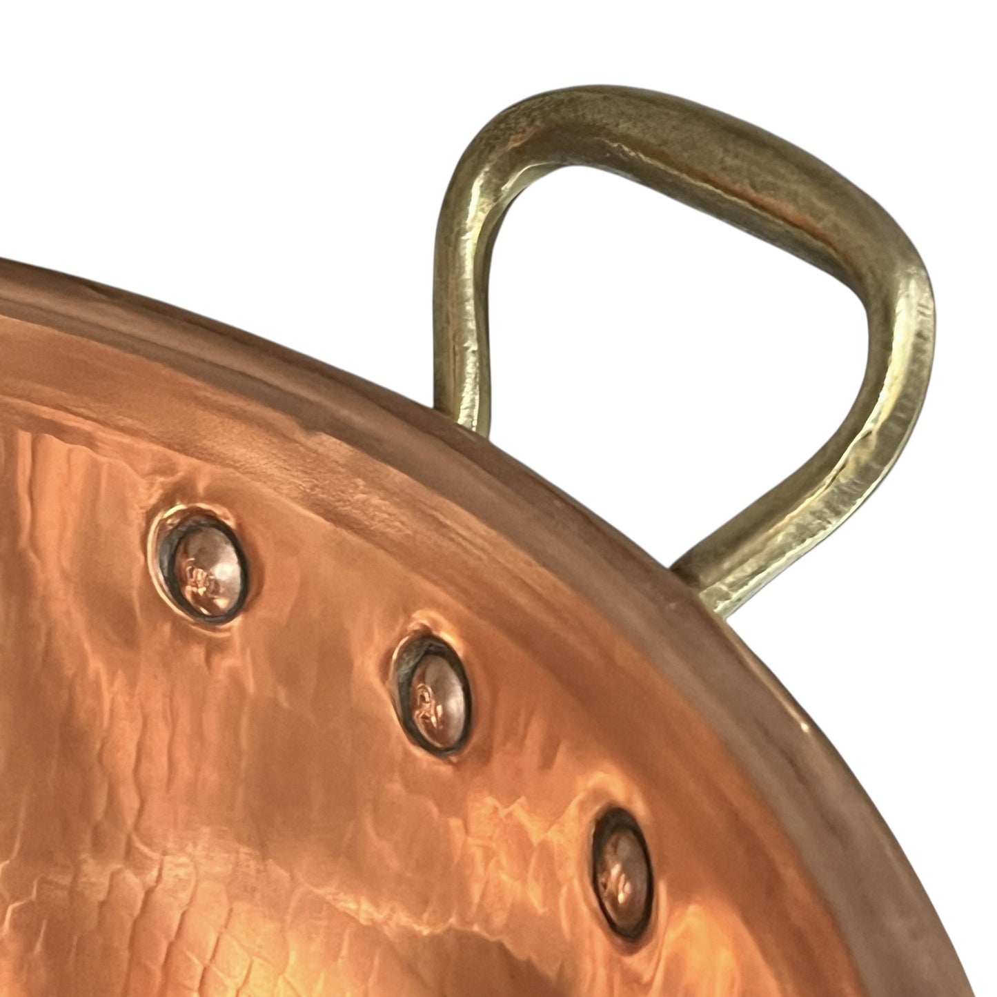 Close-up of copper sink with brass pop up waste on a white background