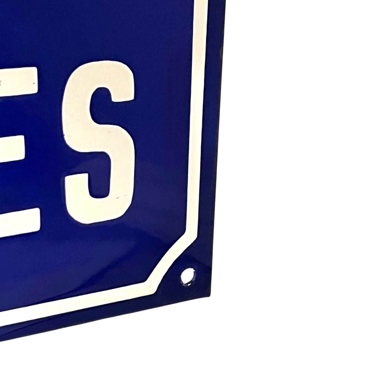 Close-up of a blue and white sign on a white background