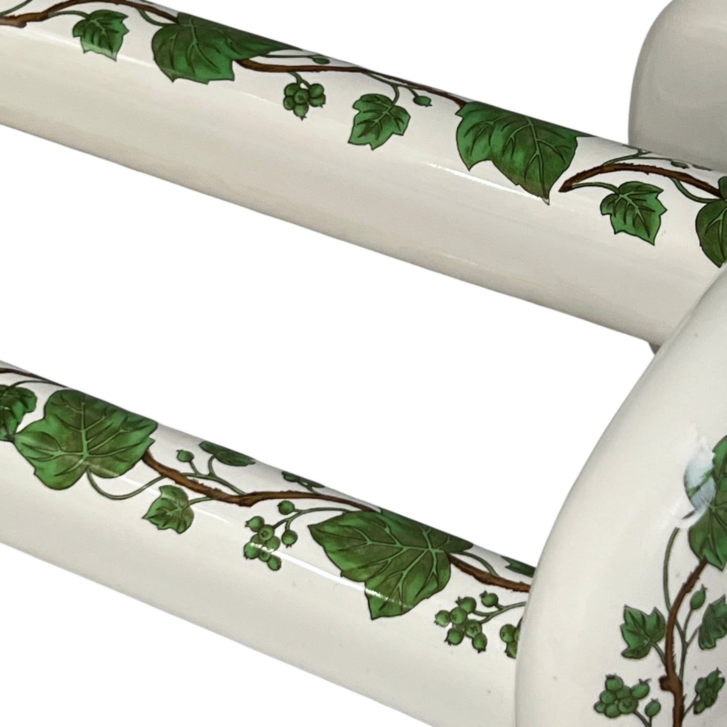 White and green leaf patterned towel rails on a white background