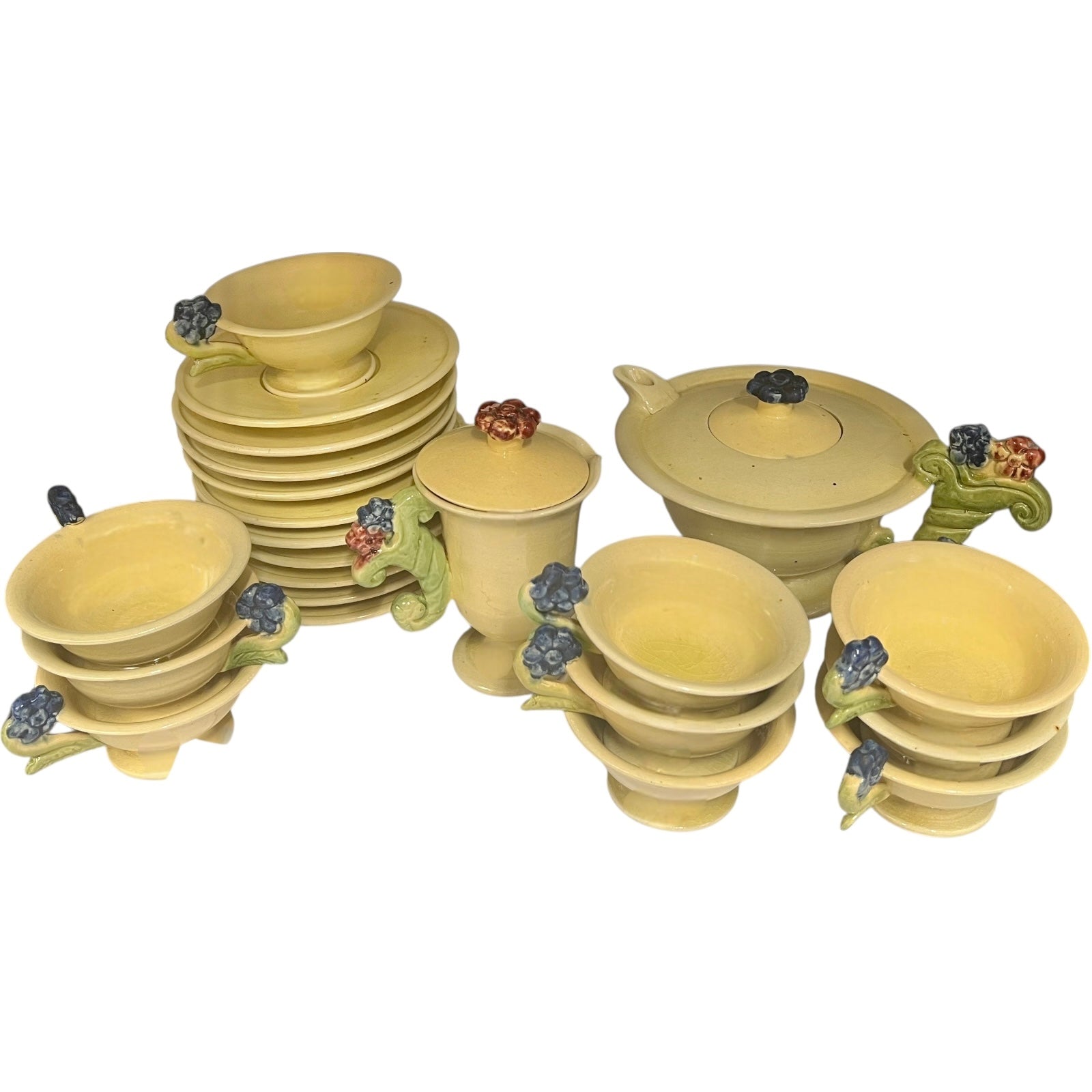 Set of ceramic cups and plates with decorative elements on a white background