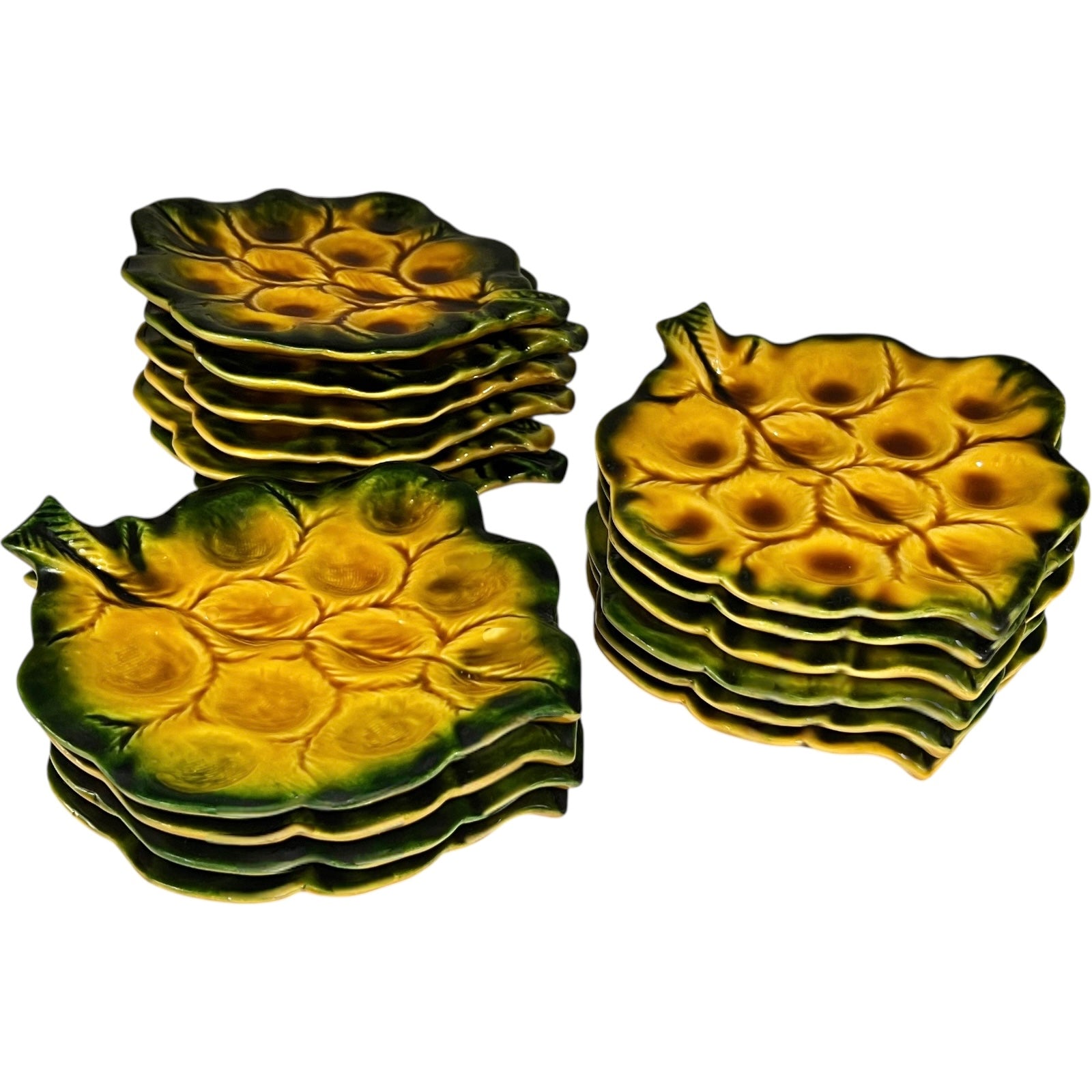 Set of green ceramic leaf-shaped snail escargots plates on a white background