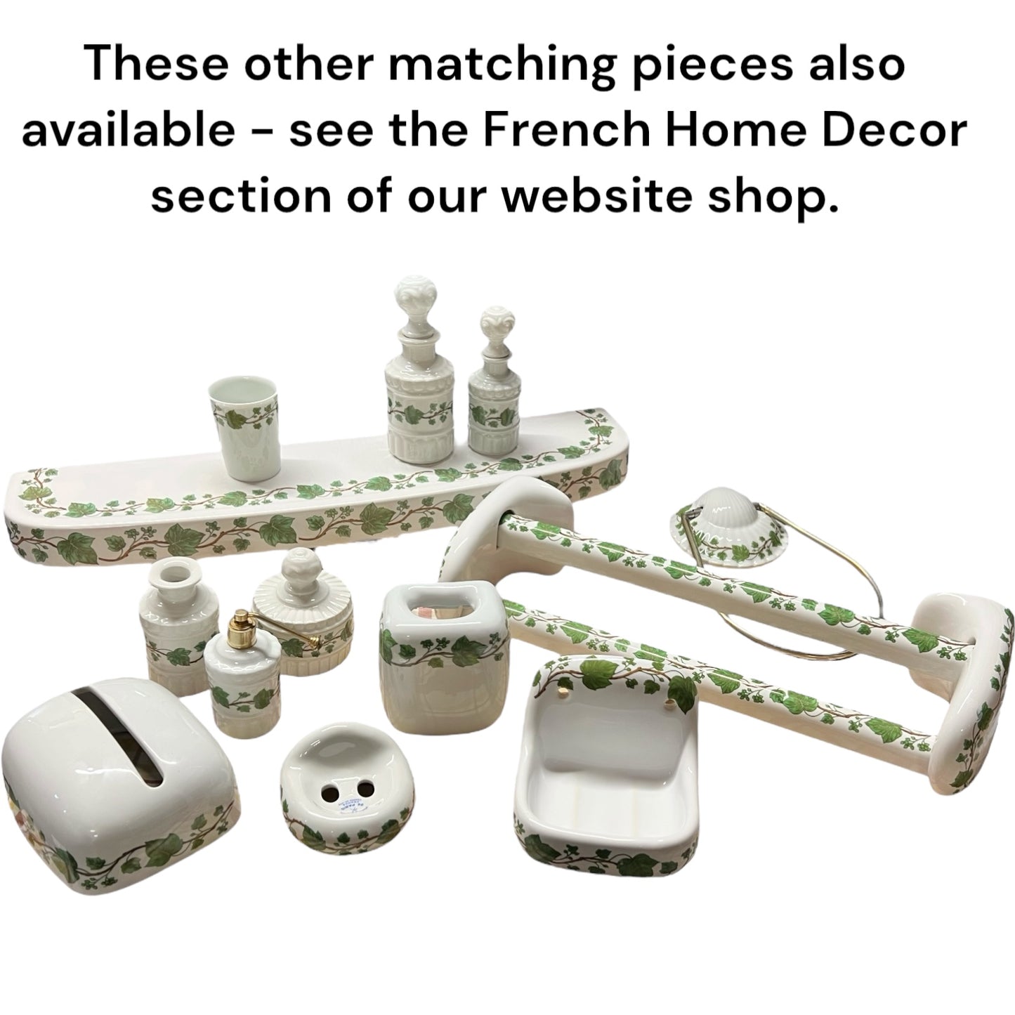 Set of white ceramic pieces with green floral patterns on a white background.