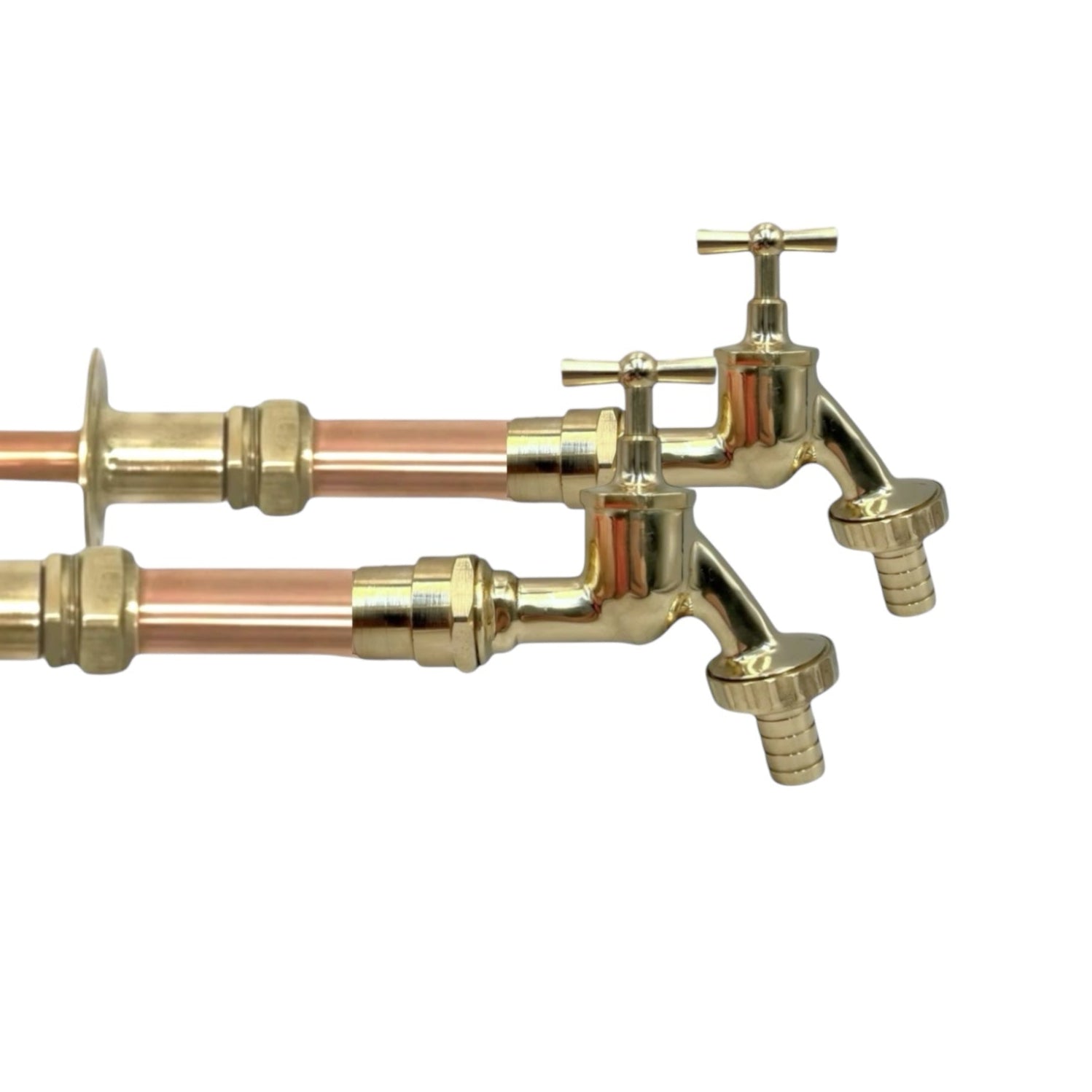 Pair of copper and brass wall taps with detachable nozzles on a white background