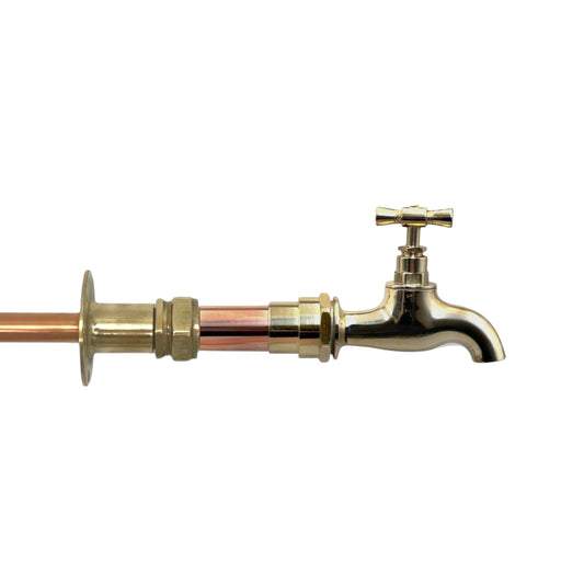 A vintage style copper and brass wall mounted kitchen or bathroom tap