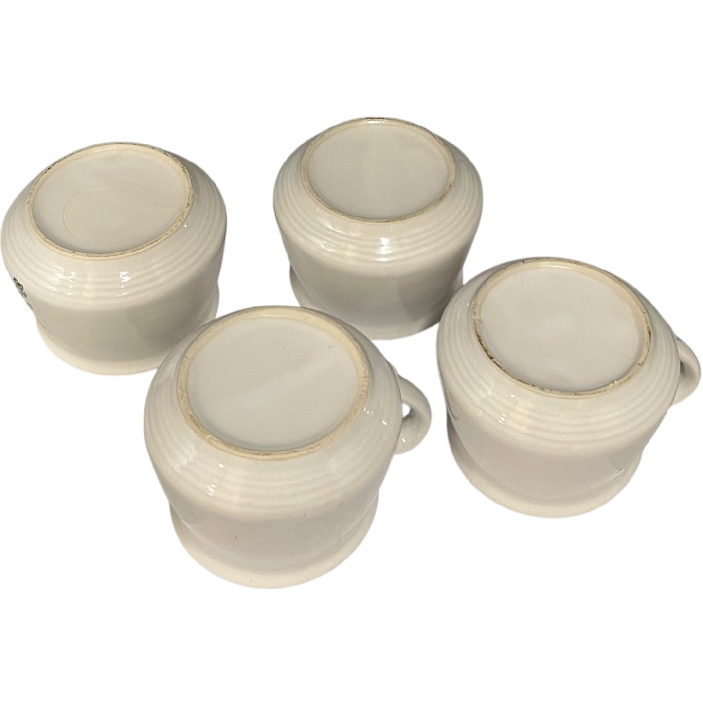 Four ceramic bowl bases with a ribbed texture on a white background