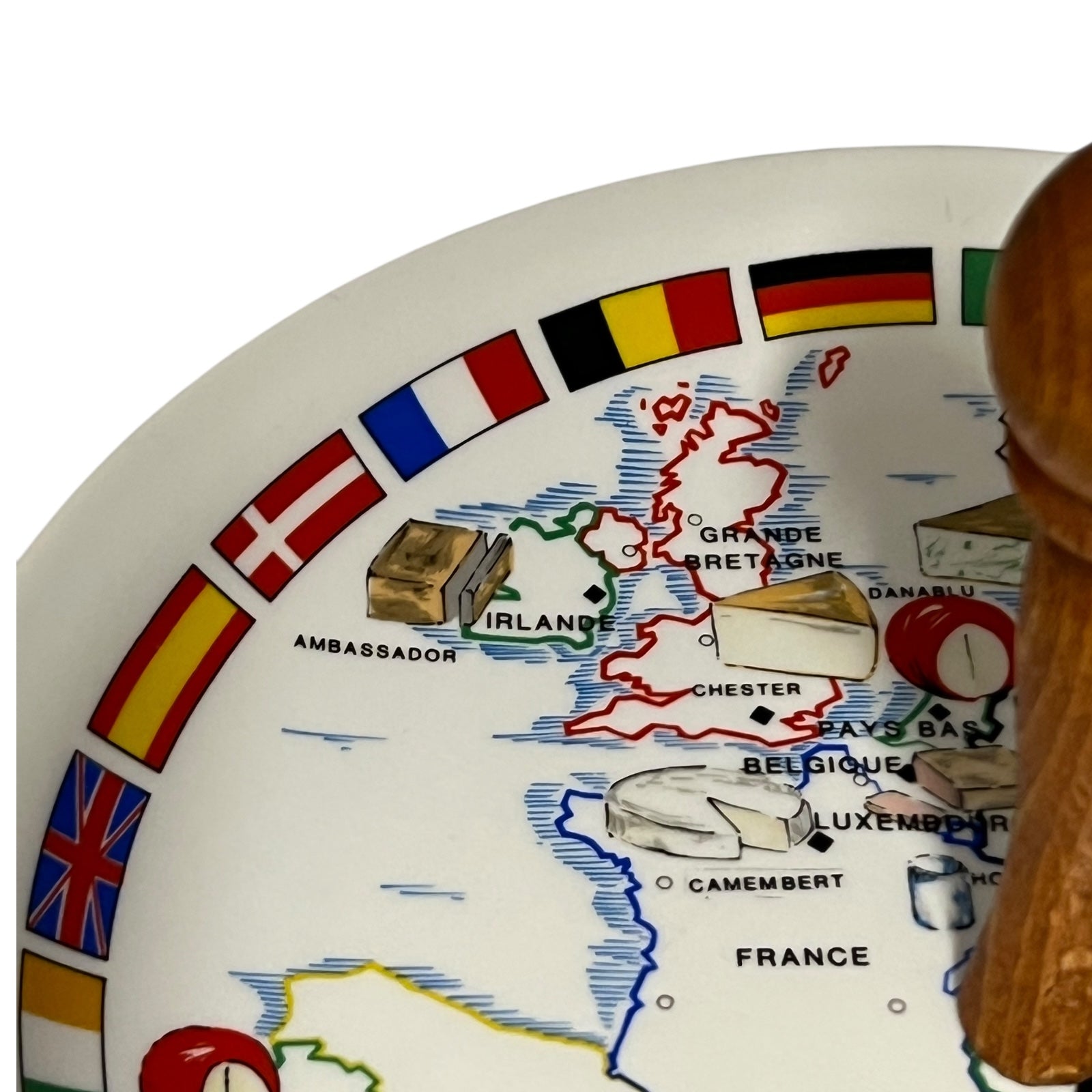 Decorative cheeseboard with a map of Europe and various flags and food items.