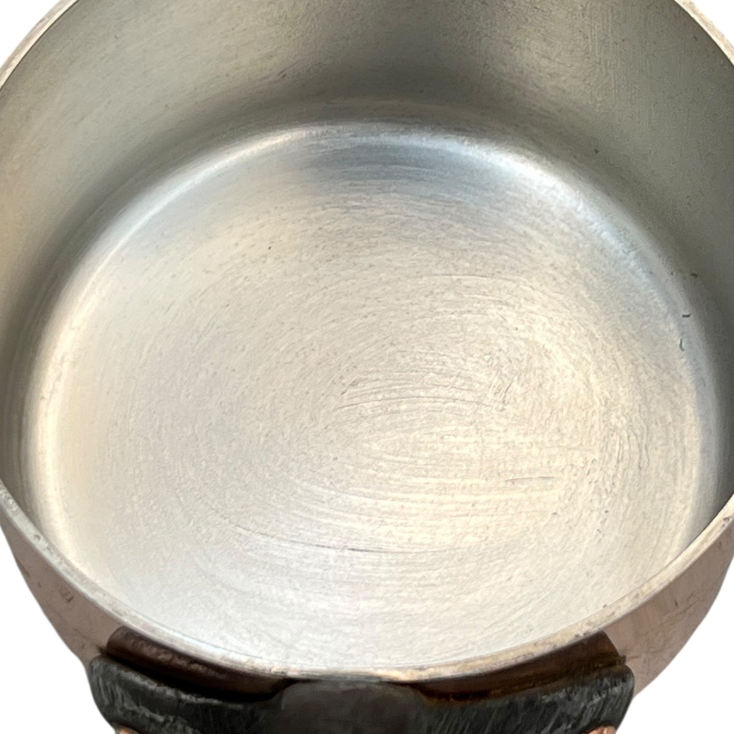 Close-up of a copper pot with a tin lined interior on a white background
