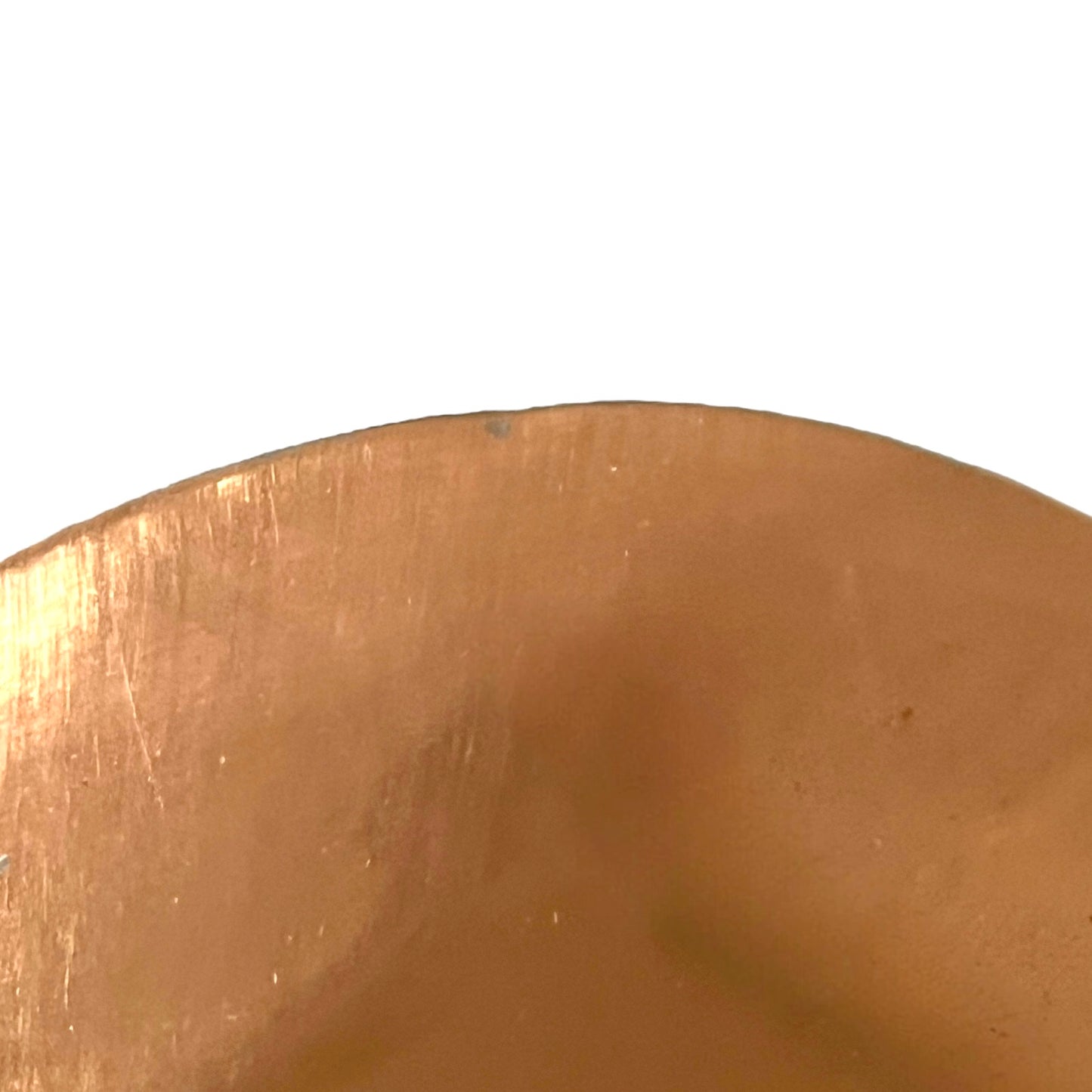 Close-up of a copper pan lid on a white background