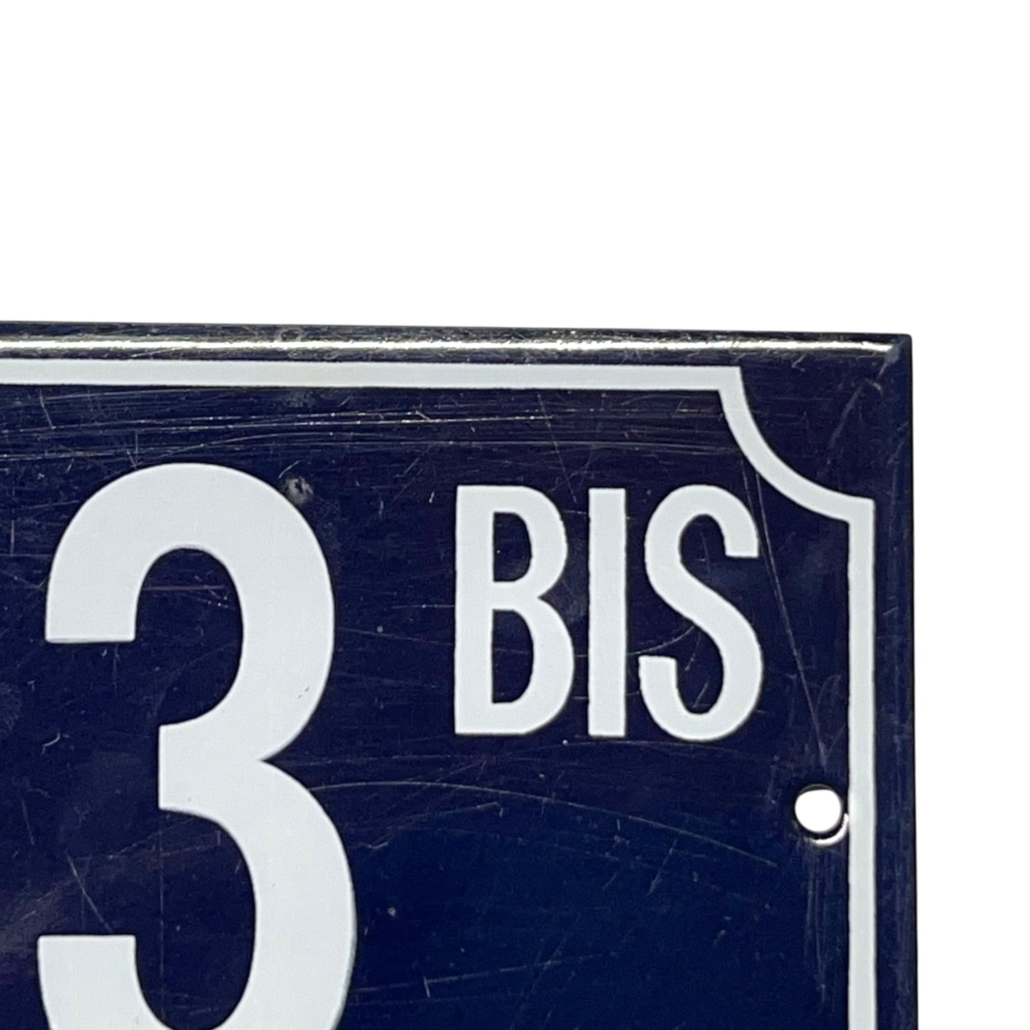 Navy blue sign with white text '33 BIS' on a white background
