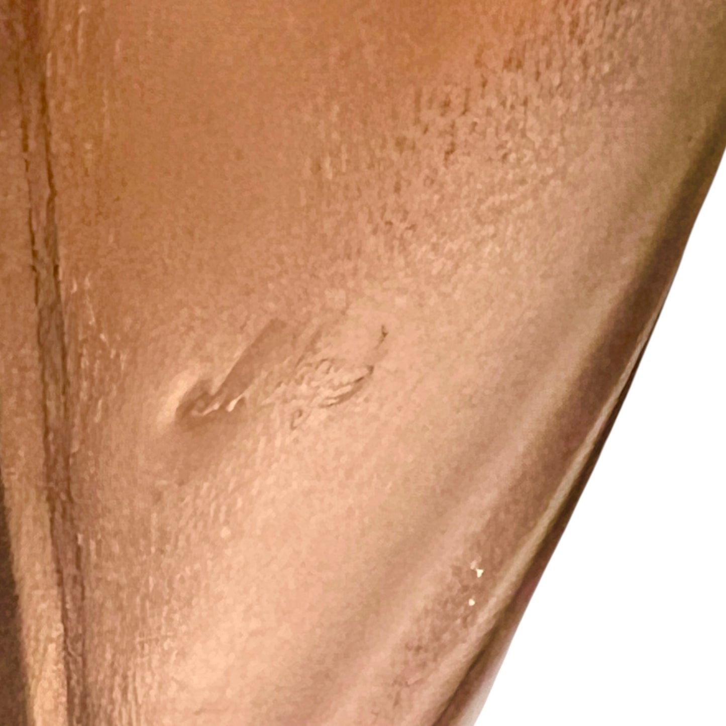 Close up of French copper bowl upcycled into a copper sink with a visible makers stamp on a white background