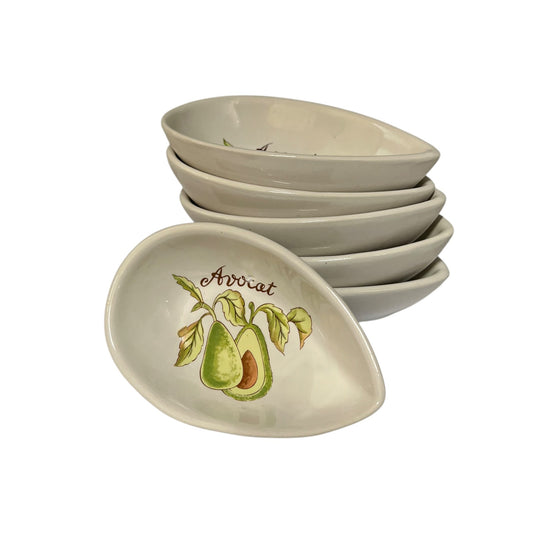 A stack of 6 oval ceramic bowls with one bowl in front, decorated with an avocado illustration and the word 'Avocat' on a white background.