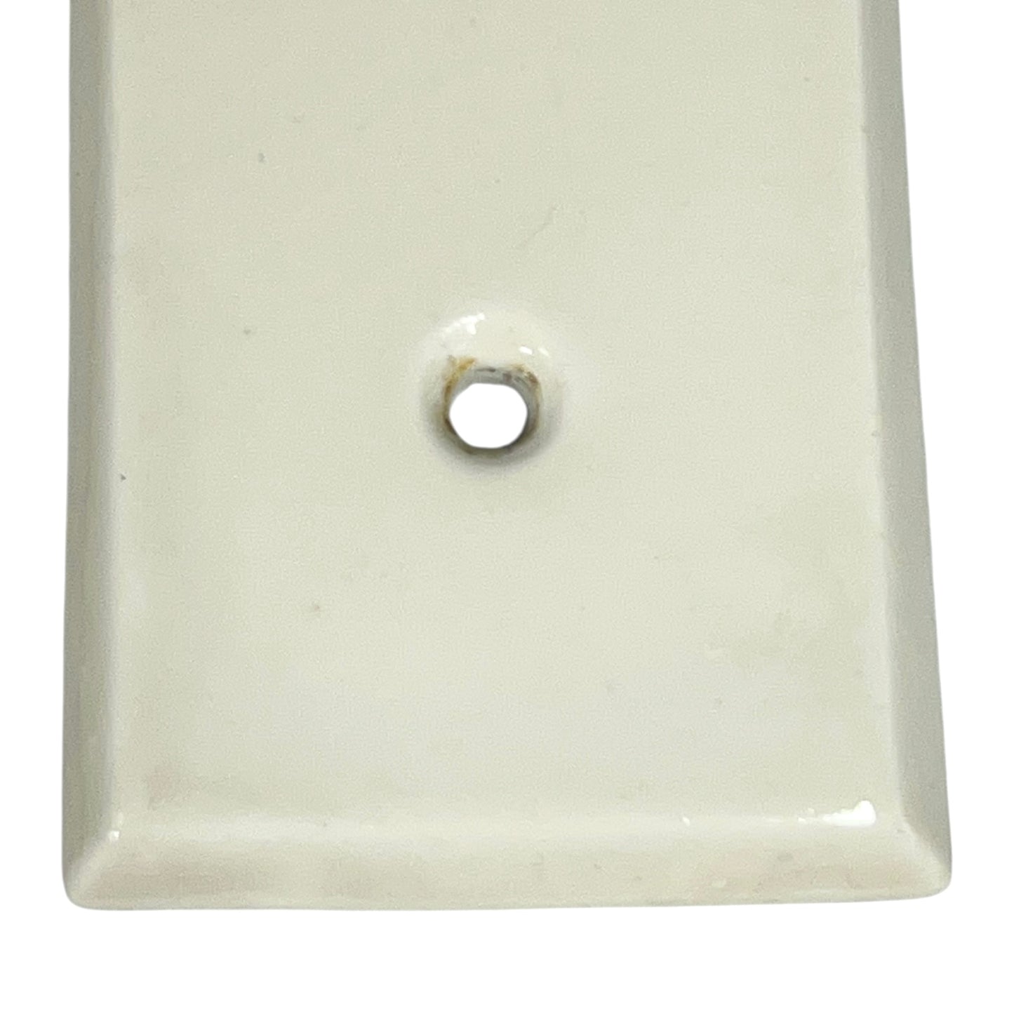 Close up of fingerplate with vintage car illustrations on a white background