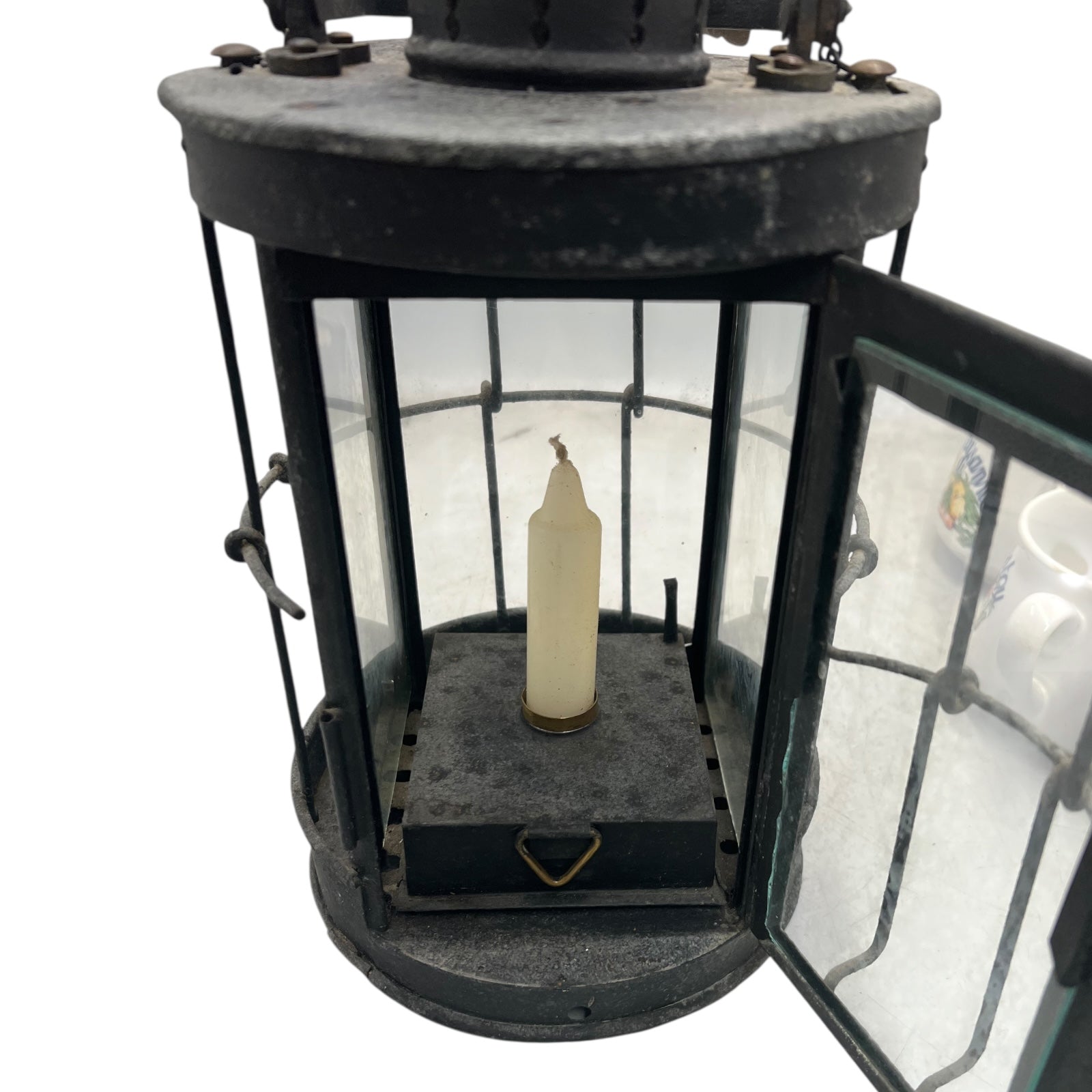 Vintage lantern with a candle inside on a white background