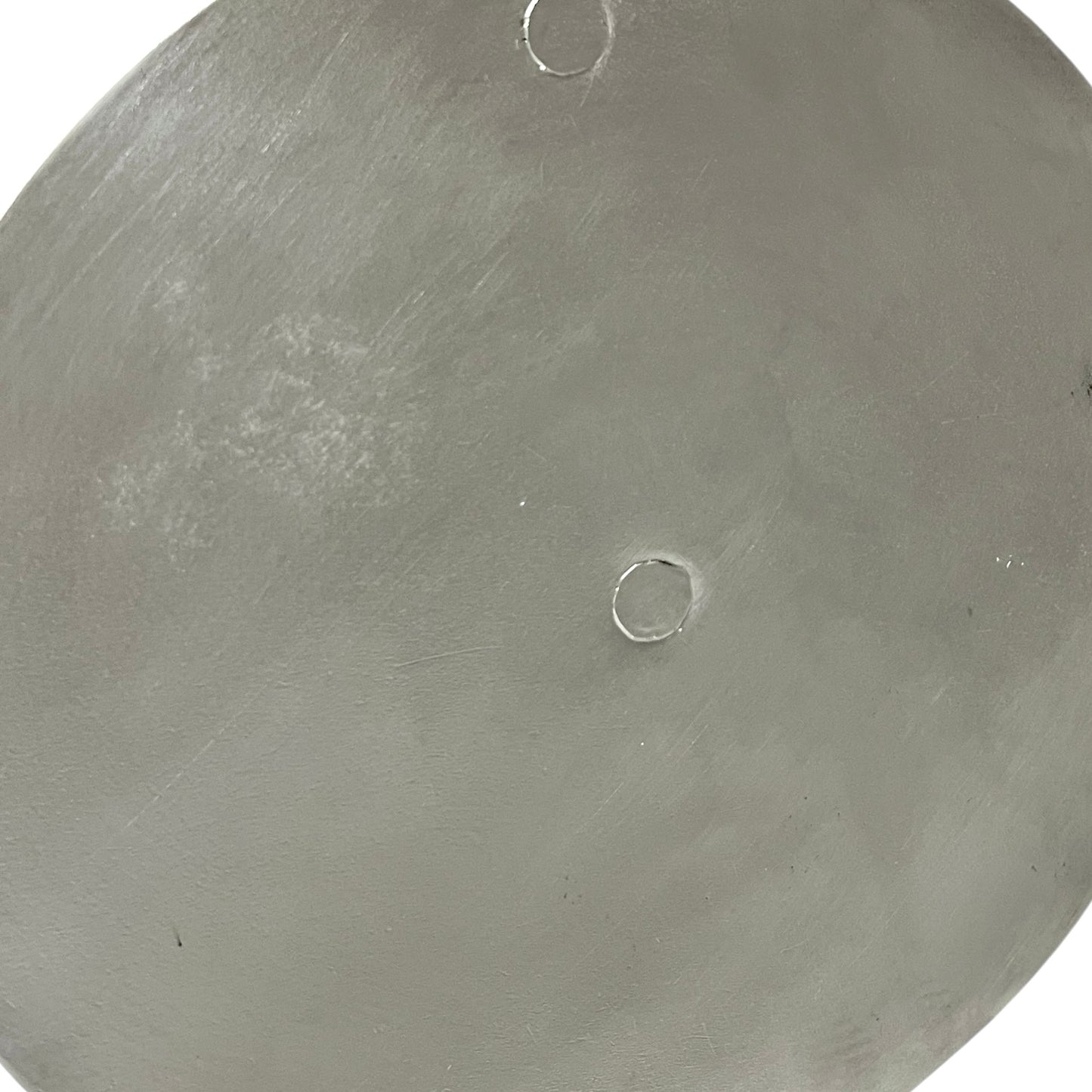 Close up French copper pan lid showing hand wiped traditional new tin lining on a white background