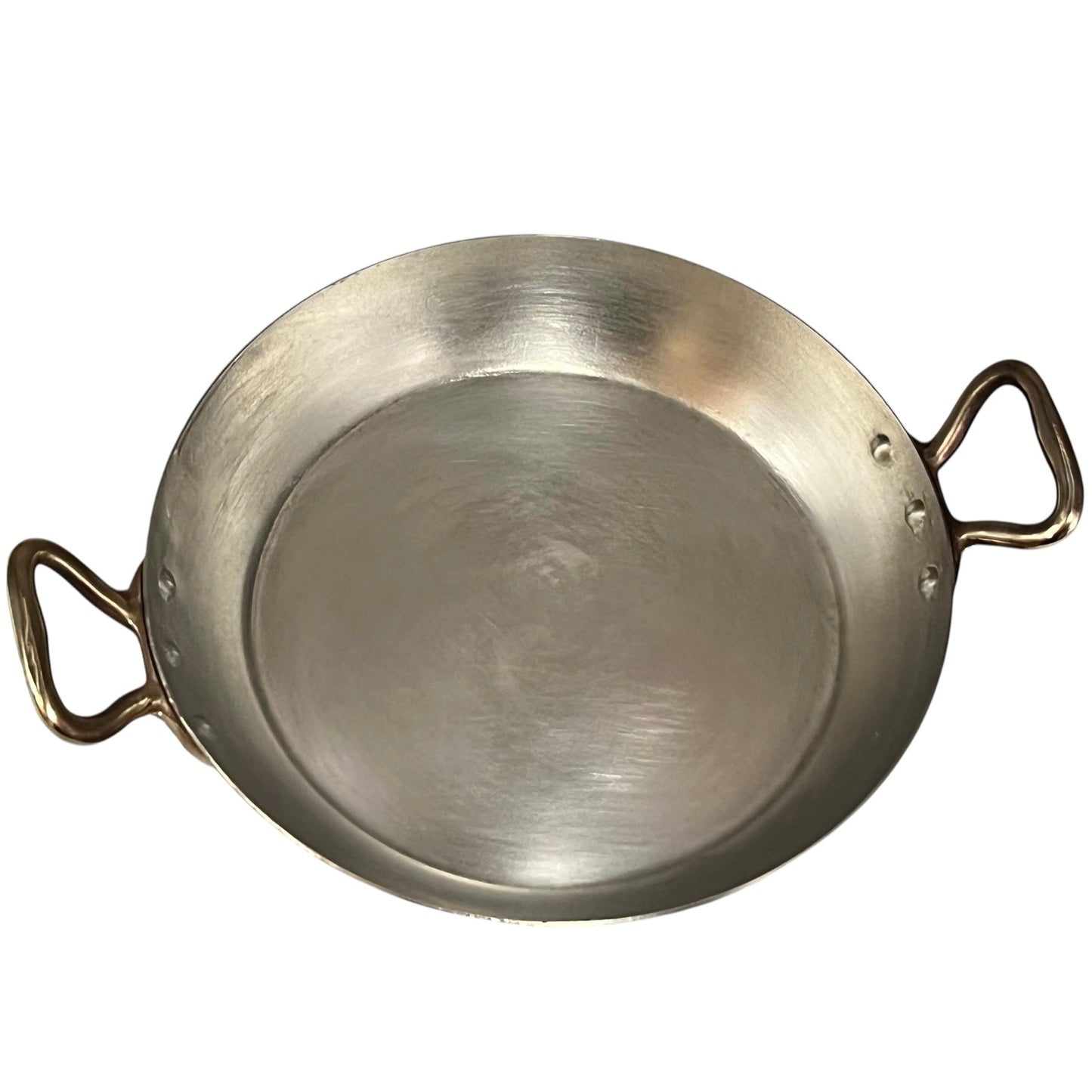 close up of French copper round gratin pan with brass handles and tin lining on a white background