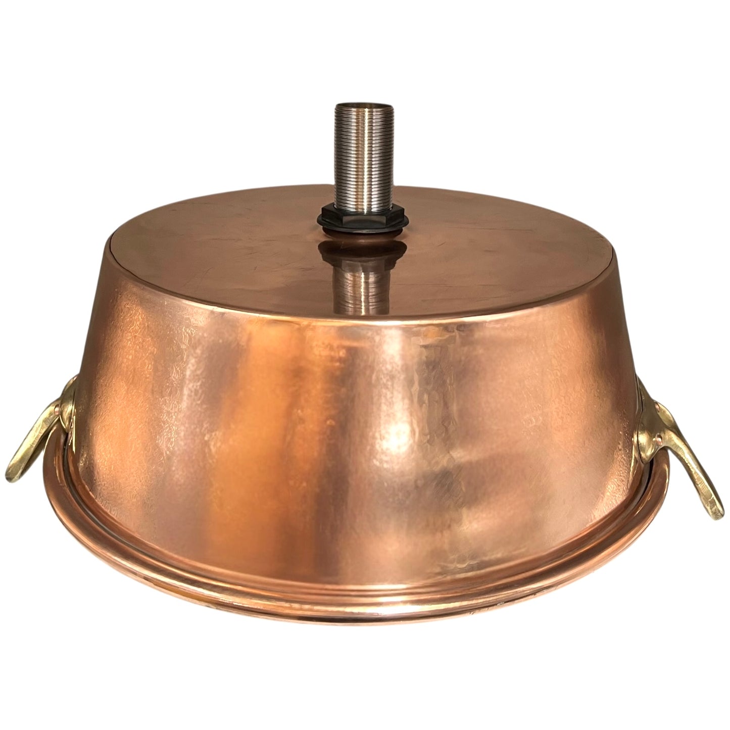 Close-up of copper sink with brass pop up waste on a white background