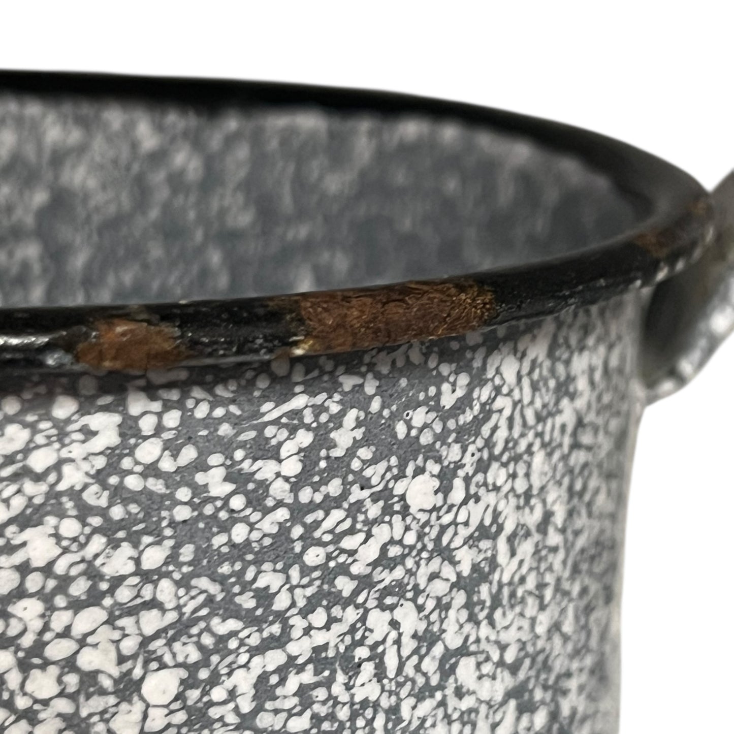 close up of vintage French grey and white speckled irrigator with a spout and a handle showing wear and tear on a white background