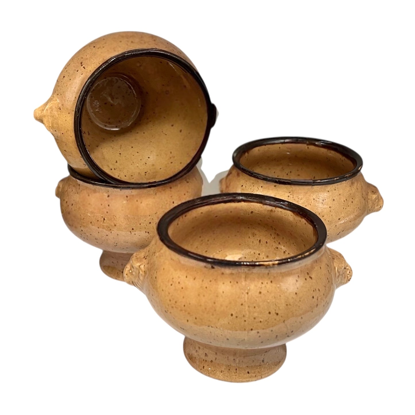 Set of four speckled beige lions head soup bowls with dark rims on a white background