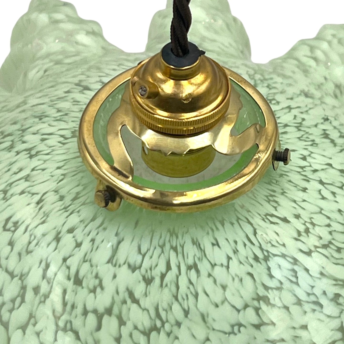 close up of light green milk glass pendant shade on a white background