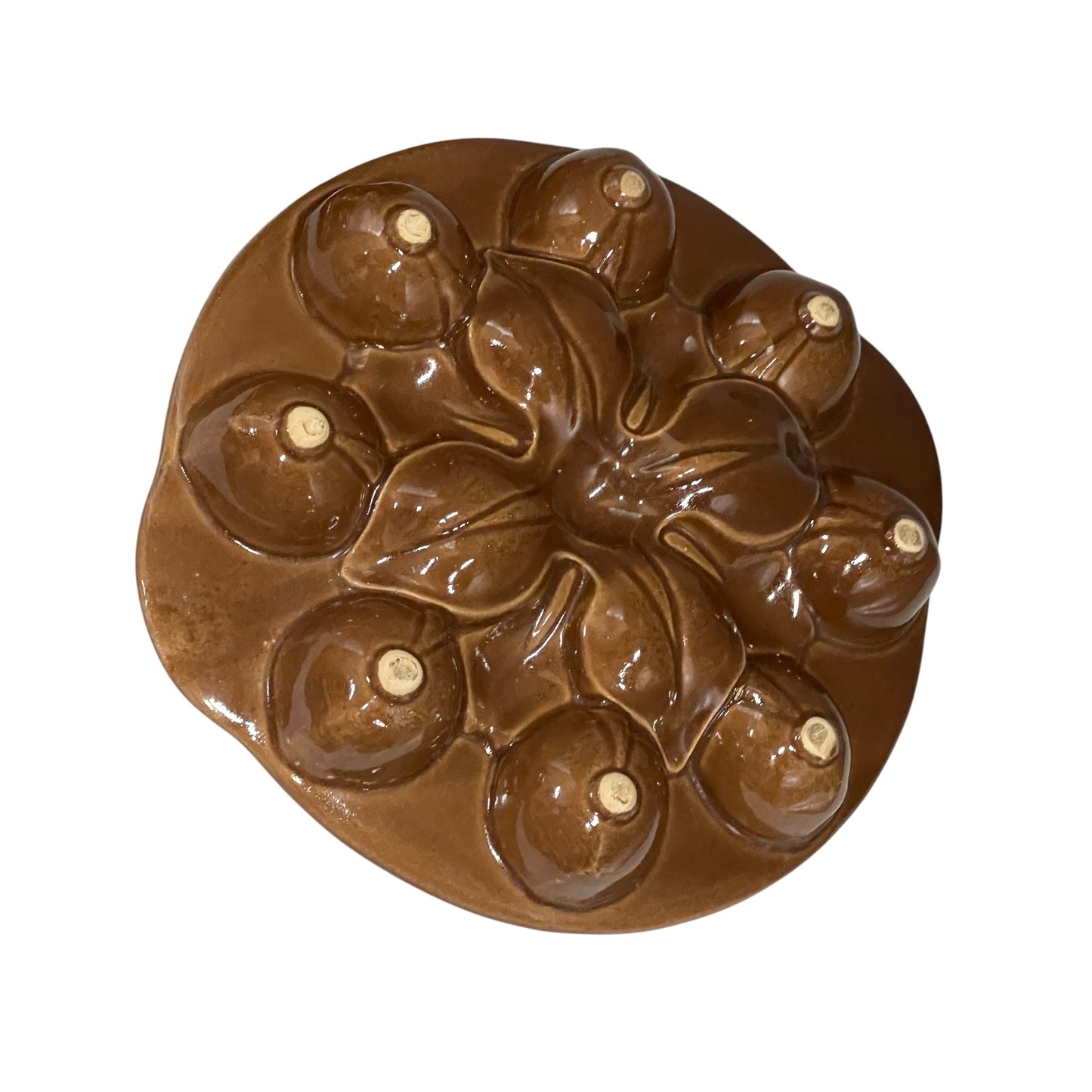 Close-up of French escargot serving plates on its underside against a white background.