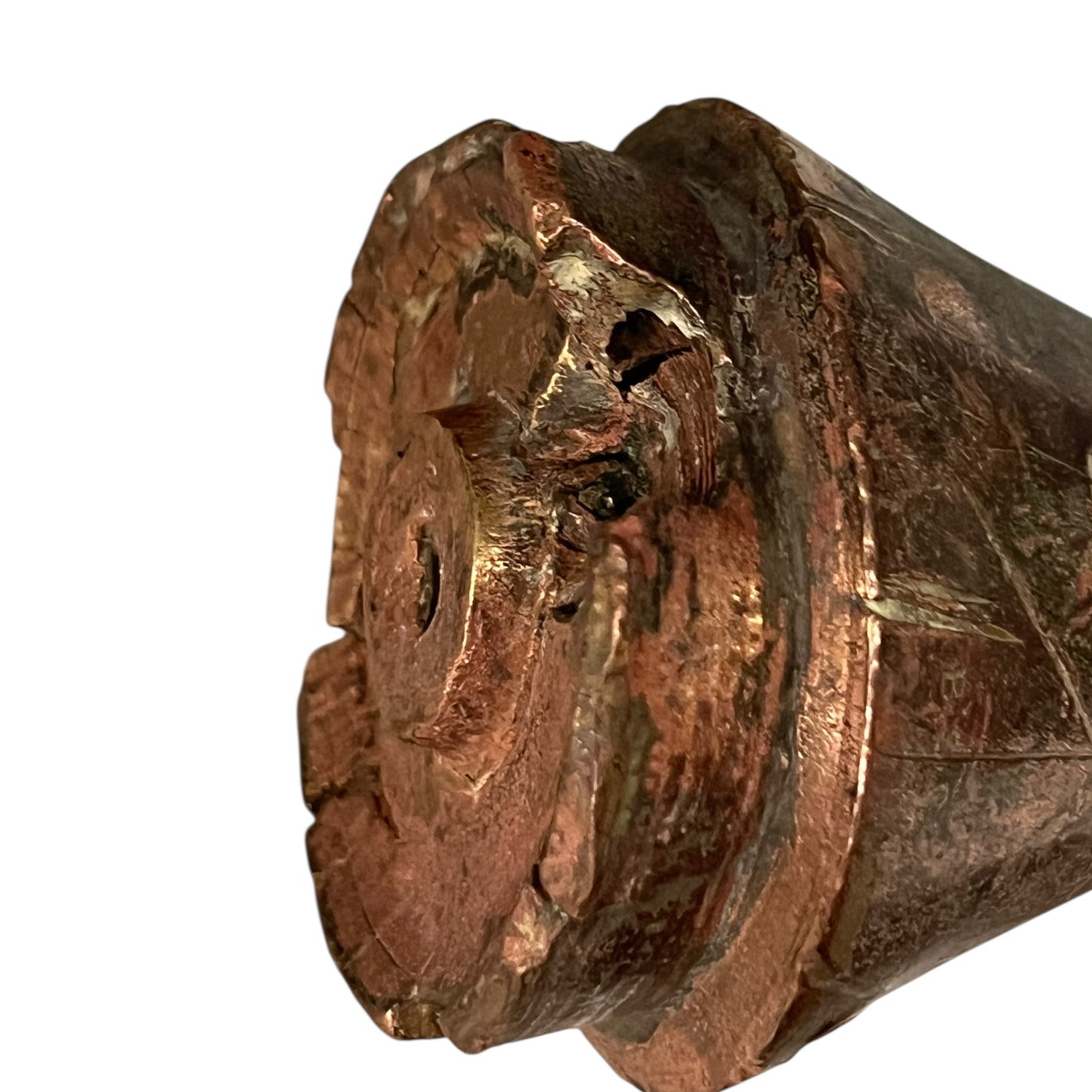 WW1 British brass fuse now repurposed as a paperweight on a white background
