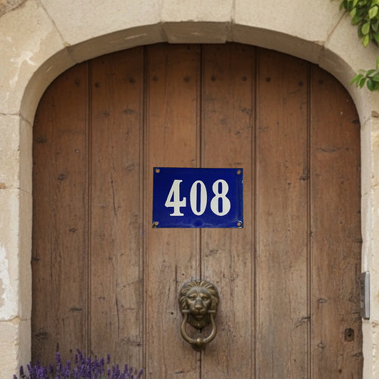 Wooden door with a blue sign displaying the number 408 and a lion knocker.