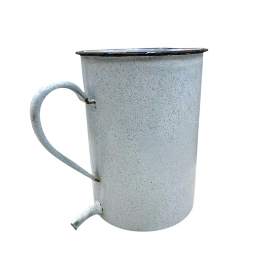 White speckled enamel jug with a handle on a white background