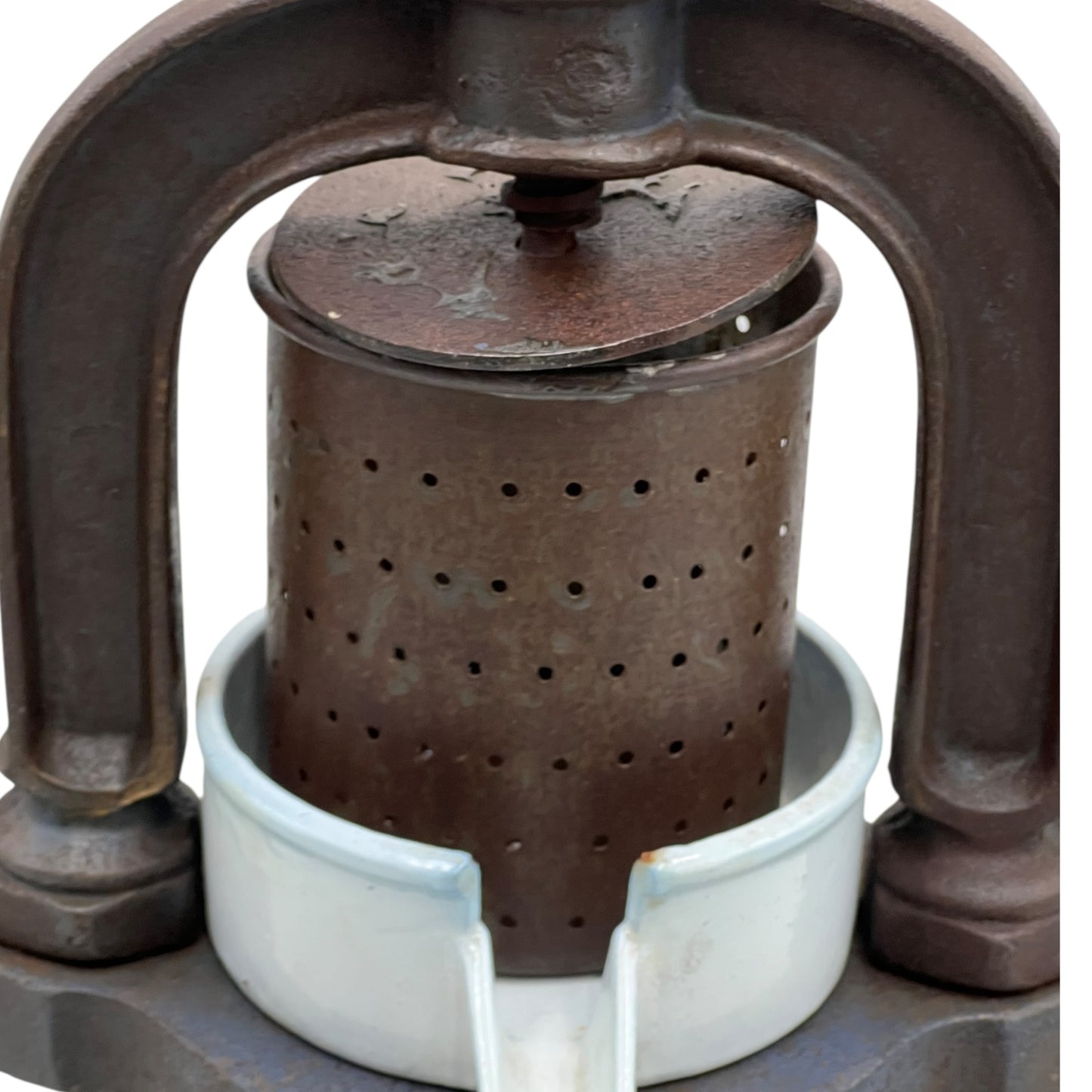 Close-up of a vintage French fruit press with an enamel pot on a white background