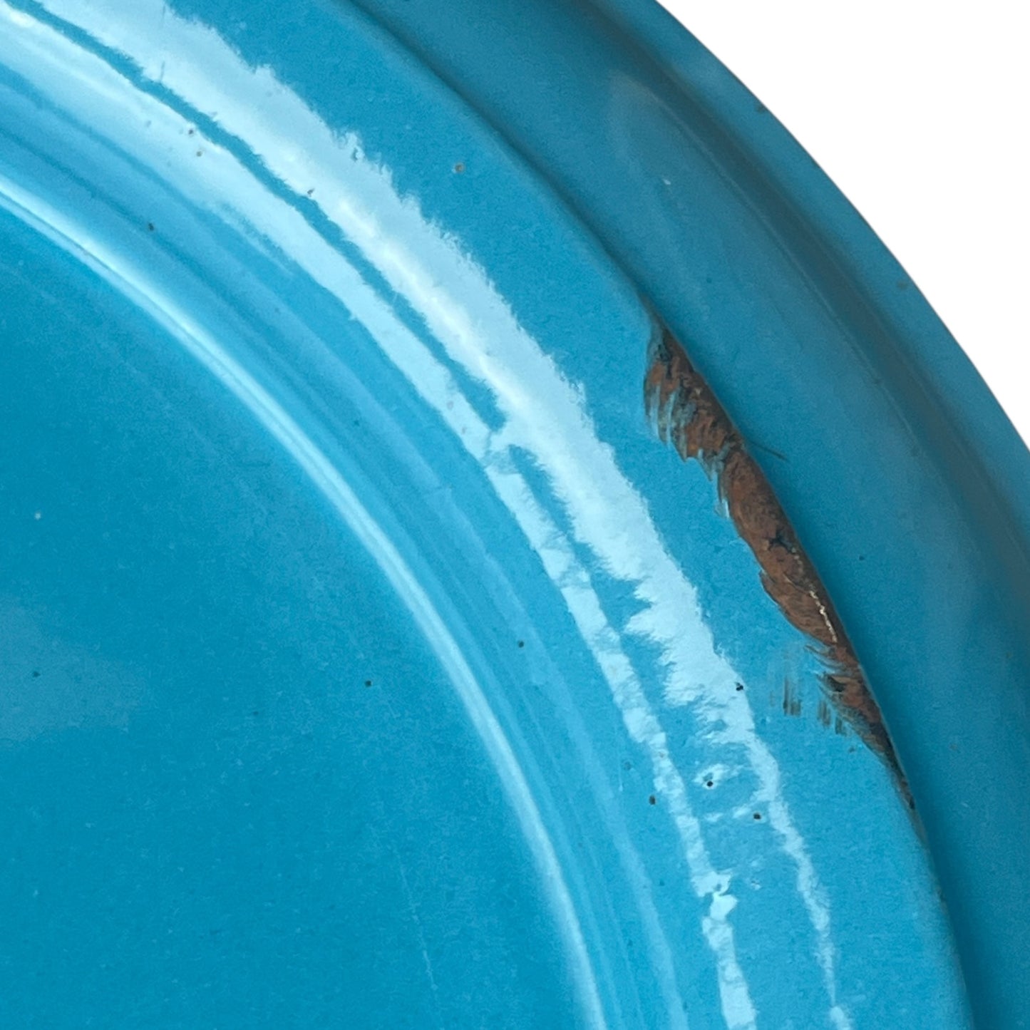 Close up of blue metal bucket with a wooden handle on a white background
