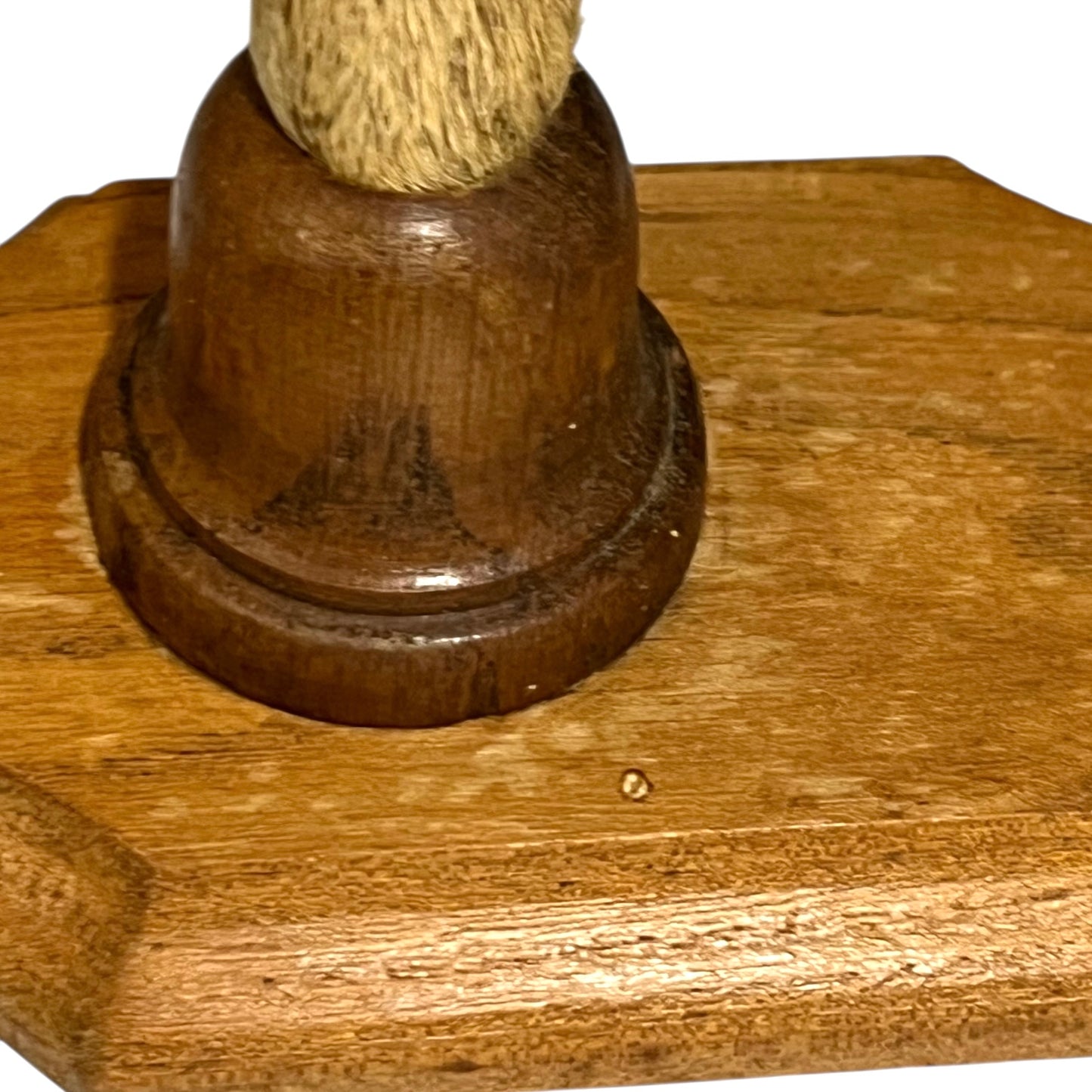 Close up of deer hoof hooks on wooden mounts on a white background
