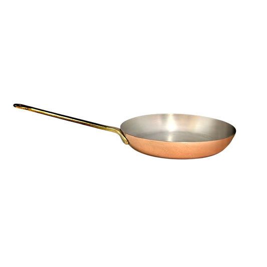 A copper frying pan with a silver interior and a long gold-toned handle, shown on a plain white background.