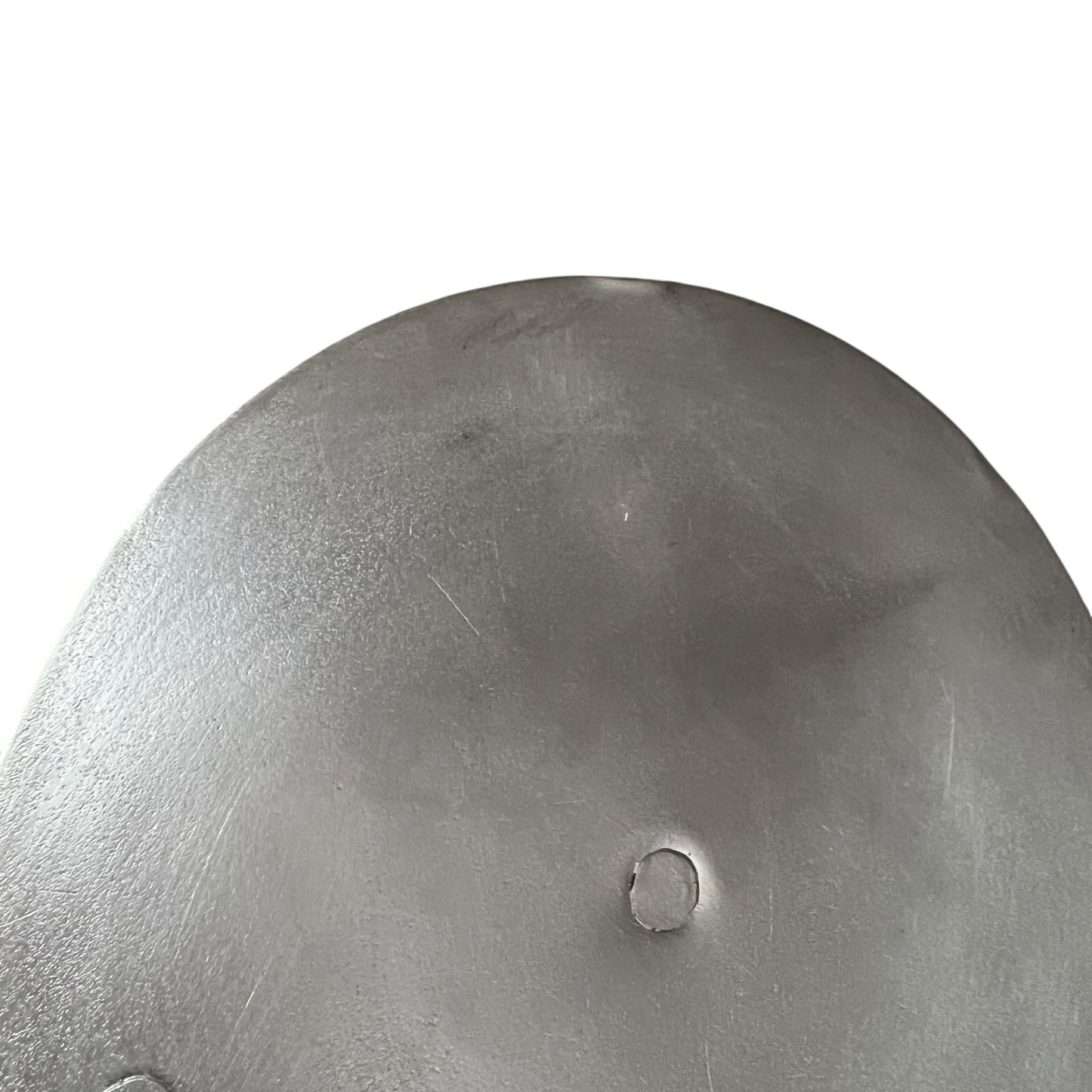 Close up French copper pan lid showing hand wiped traditional new tin lining on a white background